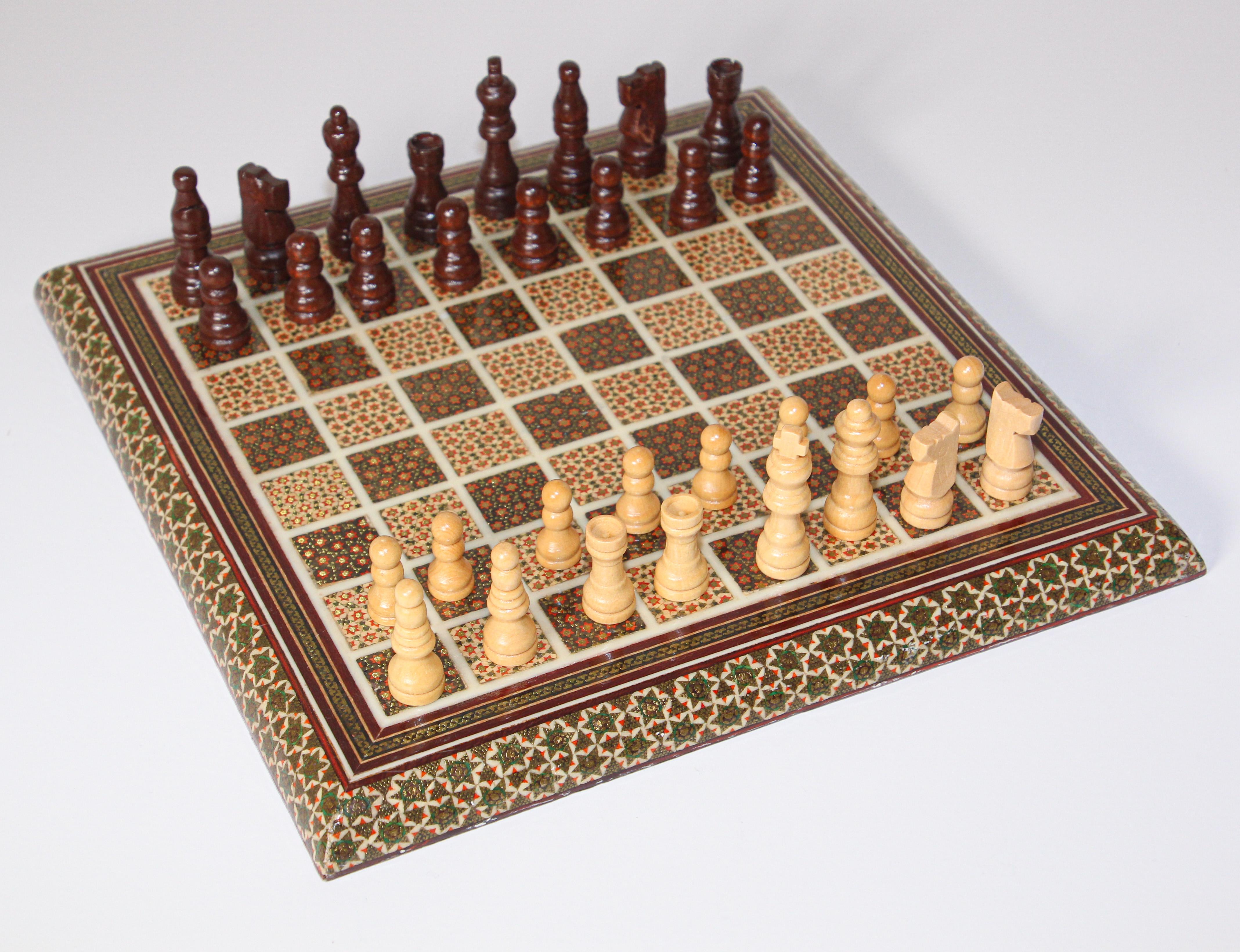 Intricately inlaid handcrafted Persian chess game board and pieces.
Handcrafted beautiful Middle Eastern Persian Khatam chess board covered with very delicate micro mosaic marquetry from the ancient Persian technique of inlaying from arrangements