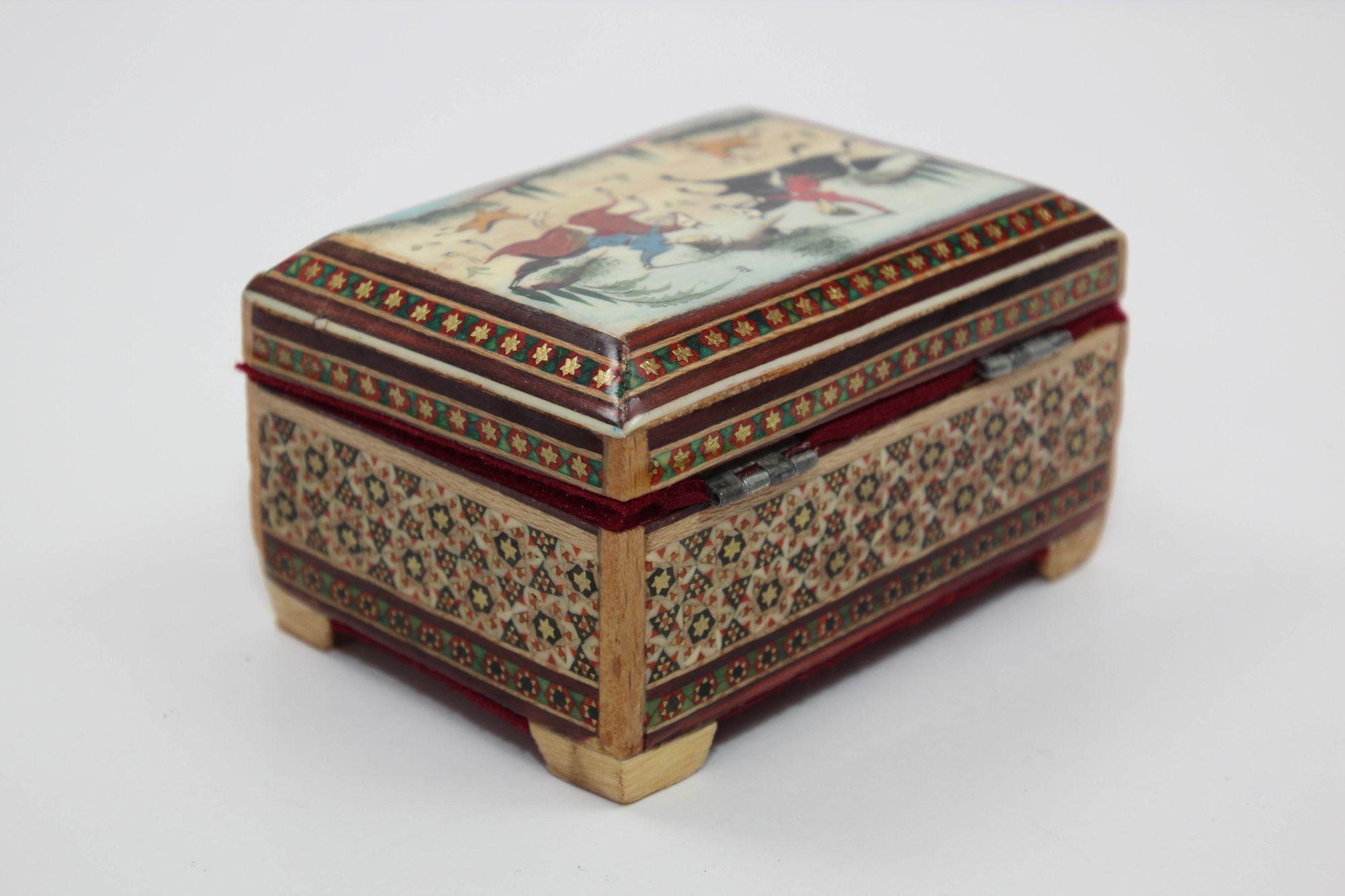 Vintage Middle Eastern Persian Khatam Trinket Box with Miniature Art Painting.
This hand-painted, lacquered wooden box features Moorish micro mosaic marquetry, perfect for holding small trinkets.
The vintage marquetry, a blend of wood inlay and