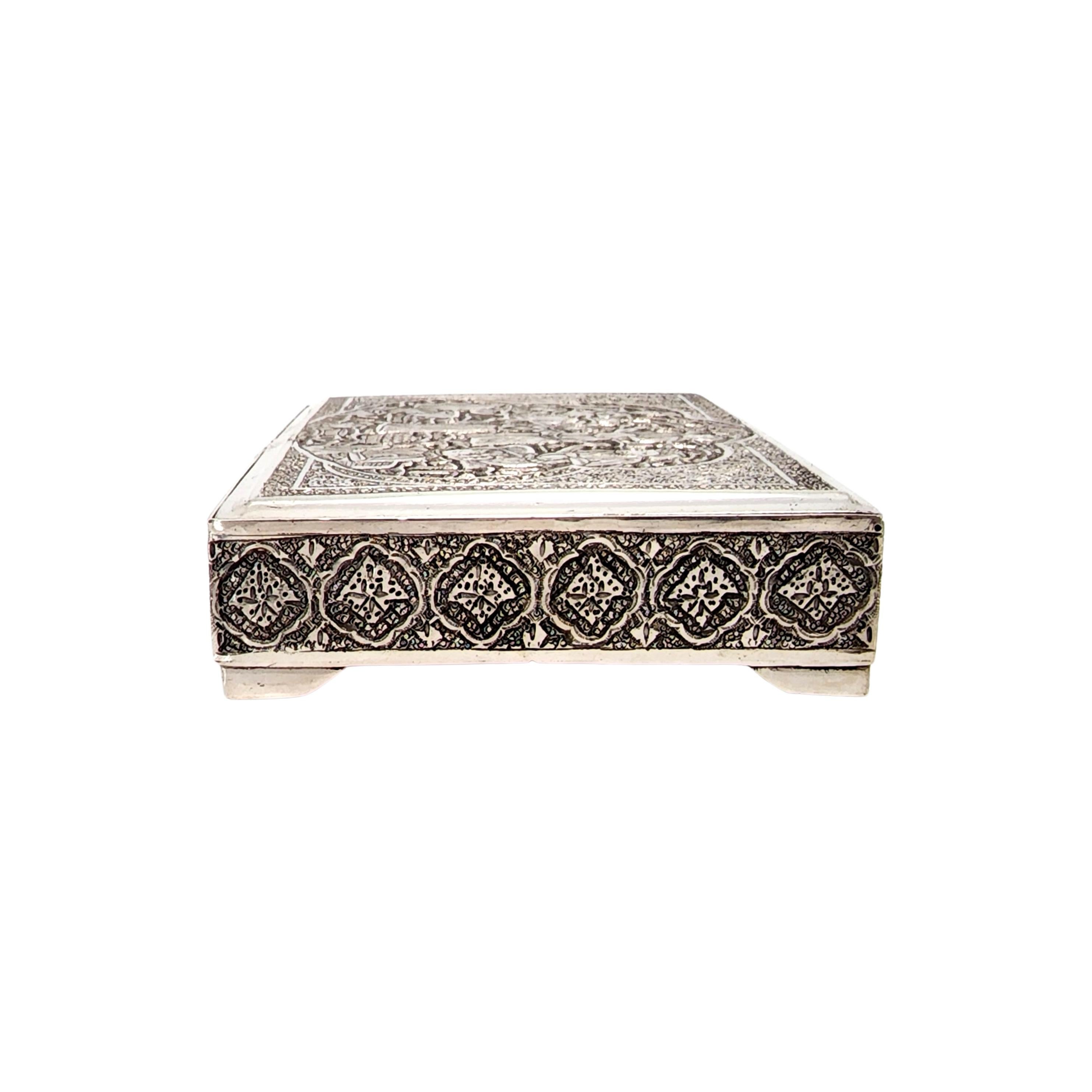 Middle Eastern Persian silver box.

Ornate designs all around the sides and top of this box. The lid features a scene of Middle Eastern people. Hinged lid.

Measures approx 5 5/8