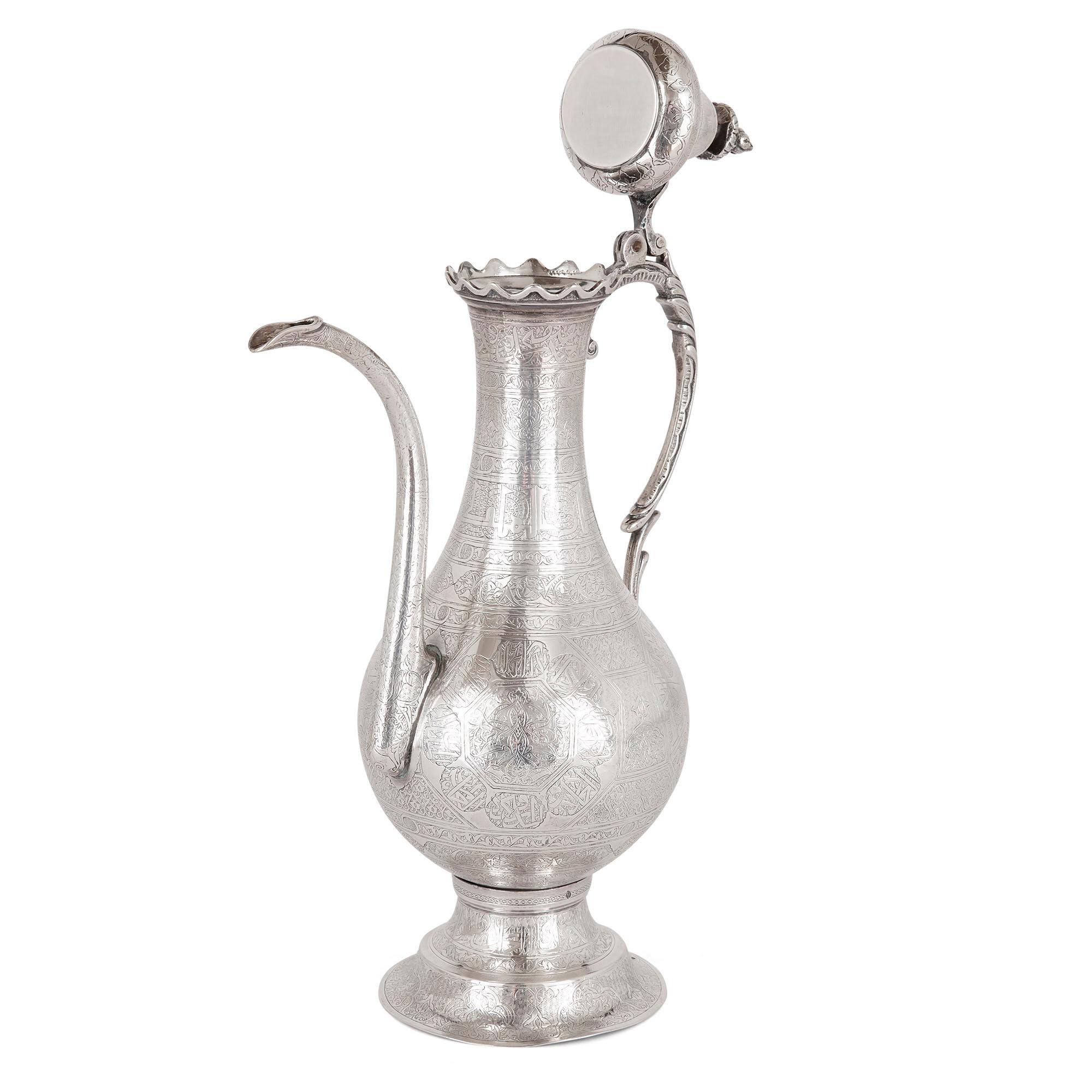 Middle Eastern silver ewer and basin
Middle Eastern, early 20th century
Measures: Ewer: Height 37.5cm, width 23cm, depth 13cm
Basin: Height 12cm, diameter 36.5cm

This silver ewer and basin, originally designed for handwashing before meals and