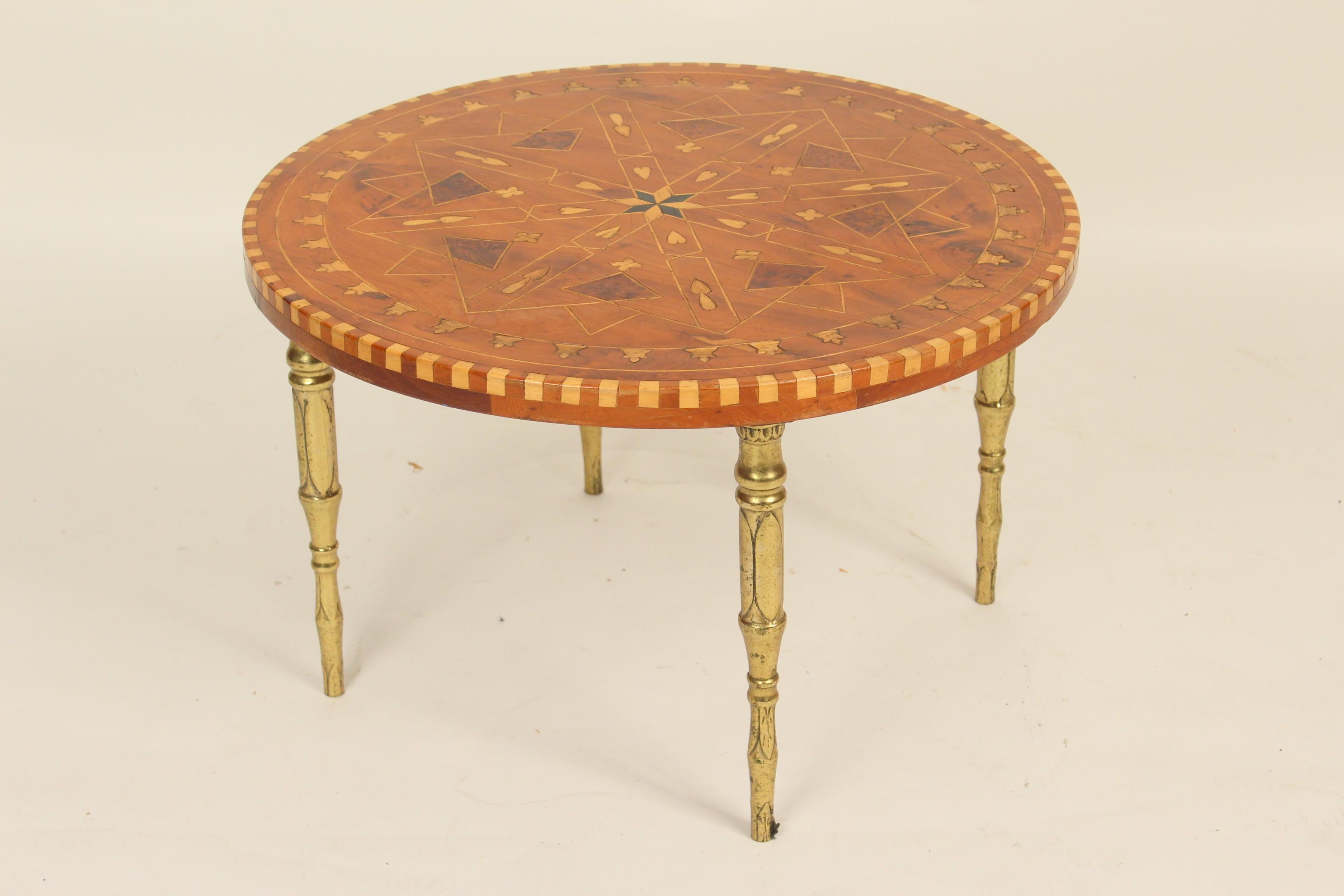 Middle Eastern style inlaid round occasional table with brass legs, mid-20th century. The bottom of the table is stencilled, 