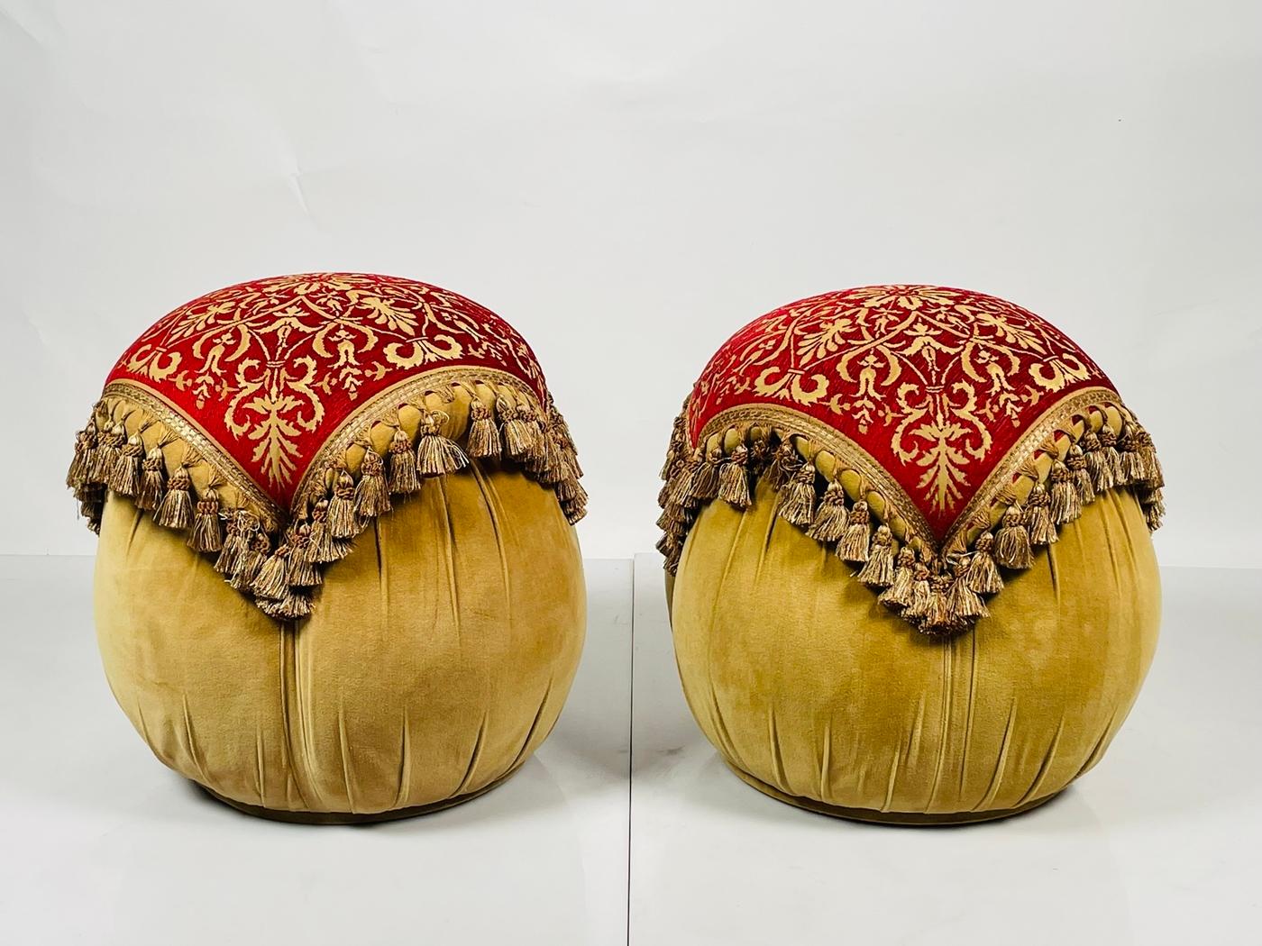Introducing our Middle Eastern Style Poufs With Tassels, USA 1970s, the perfect addition to any home seeking a touch of exotic elegance. These stunning round ottomans are crafted from luxurious velvet and adorned with intricate red and gold designs,