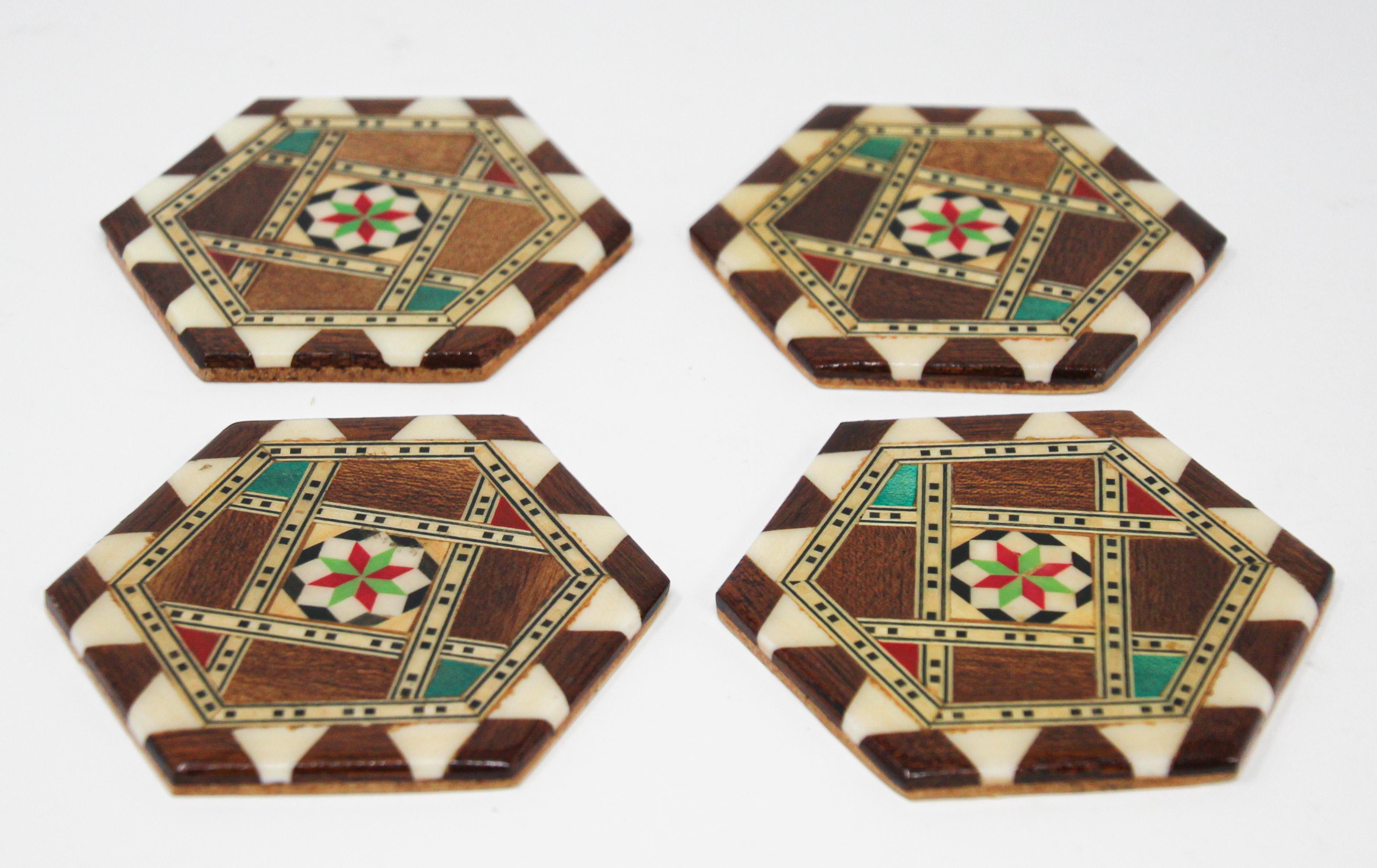 Syrian inlaid marquetry mosaic octagonal set of four cocktail coasters. 
The amazing craftsmanship in intricate marquetry fruitwood with mosaic Moorish geometric pattern and mother-of-pearl inlay makes it a true work of art. Handcrafted in the