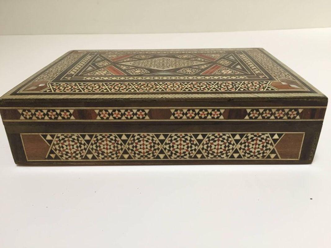 Exquisite Middle Eastern Syrian inlay jewelry box intricately inlaid with Moorish motif designs which have been painstakingly inlaid micro mosaic marquetry.
The interior is lined with red velvet and the interior top has more inlay.