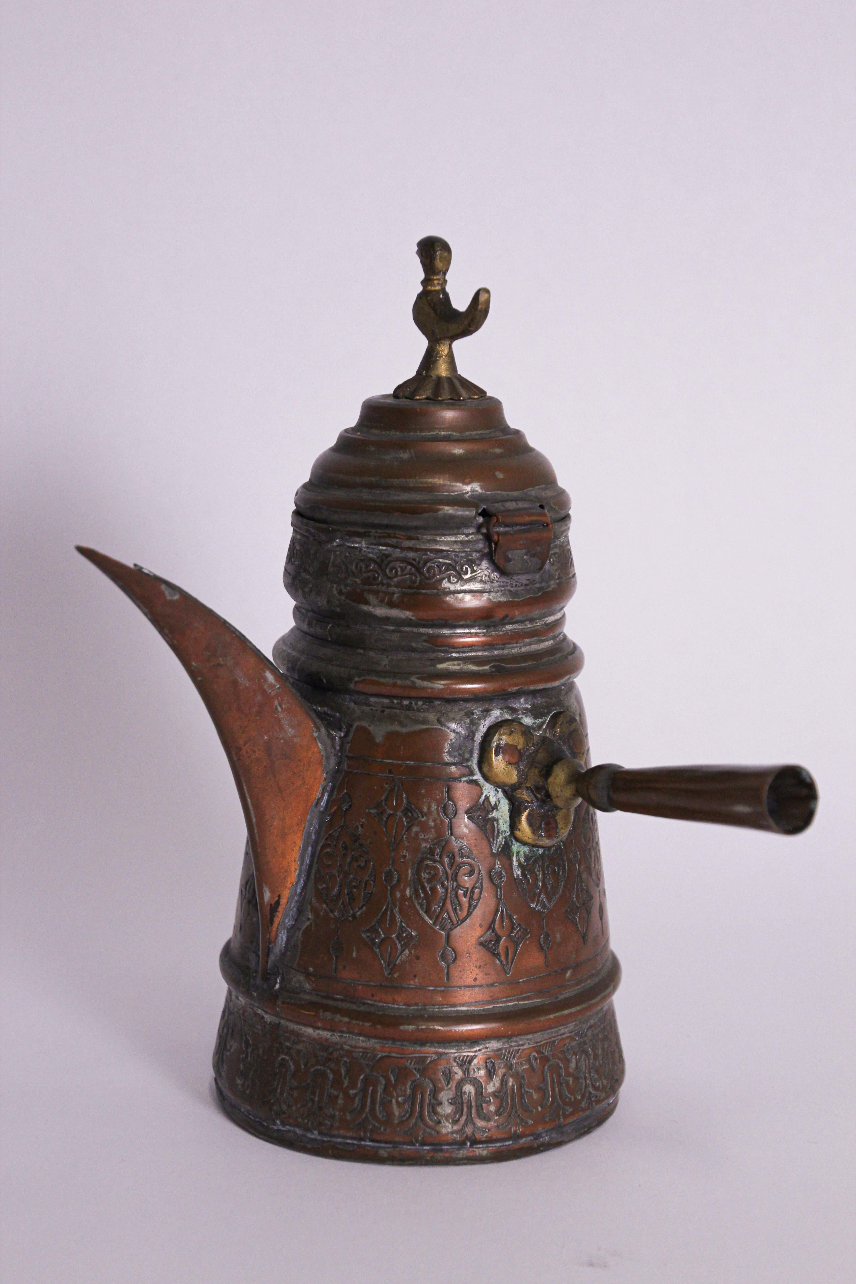 Middle Eastern Asian traditional Turkish ottoman copper Dallah coffee pot.
Coffee pot hand-hammered and chased tinned copper with riveted brass finish and a very large spout.
Small bird as final on top of the cover.
Great decorative Islamic art