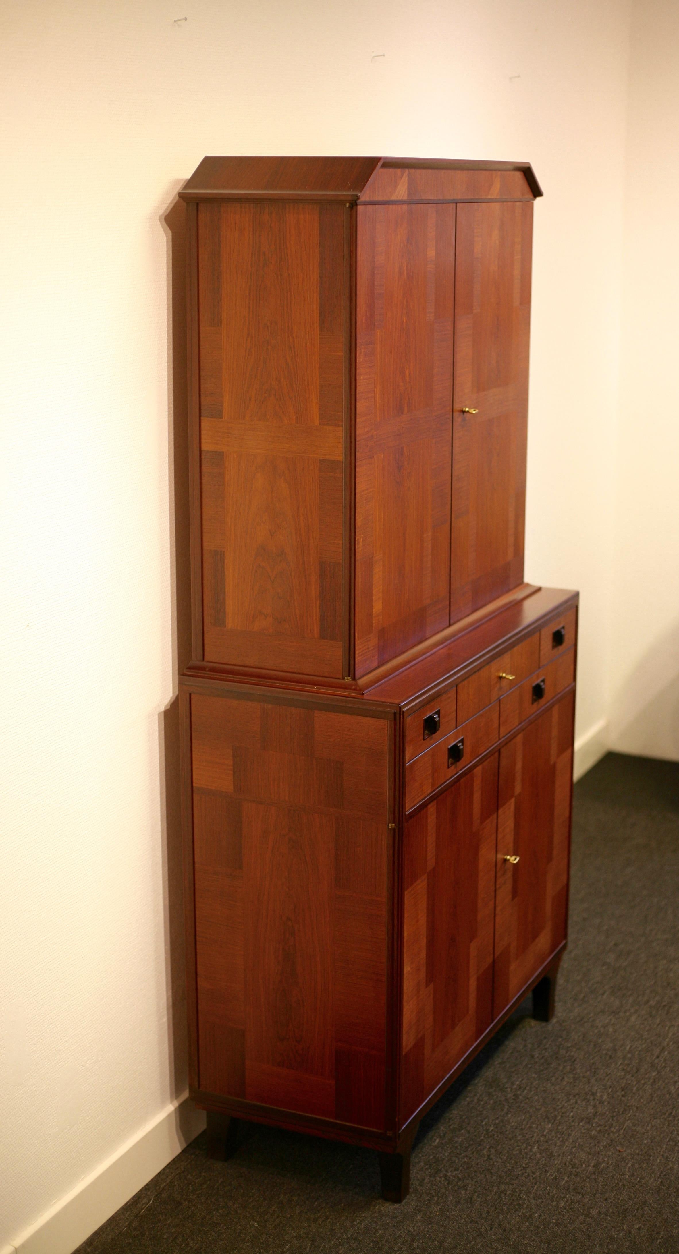 Rare and exquisite cabinet, Middle Kingdom, manufactured by Carl Malmsten´s own workshop. A variety of woods, teak, mahogany and rosewood, makes this cabinet highly exclusive since it normally only was made of one type of wood. Excellent vintage