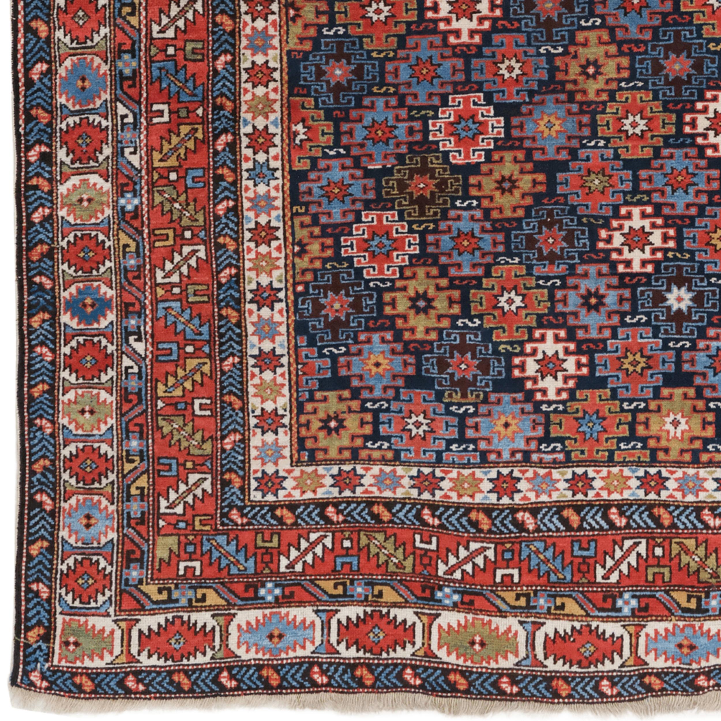 This magnificent 19th-century Chi-Chi rug boasts a rich history and unparalleled beauty. Handmade in Northwest Iran, it reflects traditional Caucasian motifs.

The deep navy blue background of the rug contrasts beautifully with the vibrant red,
