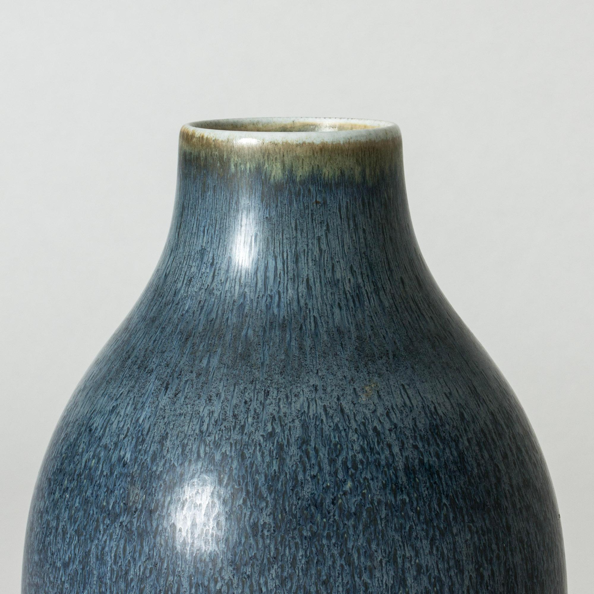 Statuesque stoneware floor vase by Carl-Harry Stålhane, in a clean form with beautiful blue glaze with a somewhat grainy look.

Carl-Harry Stålhane was one of the stars among Swedish ceramic artists during the 1950s, 1960s and 1970s, whose designs