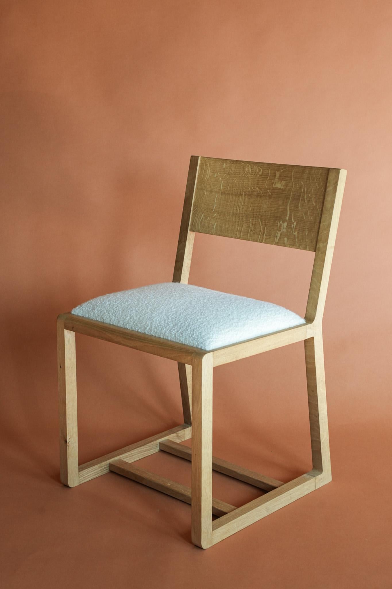 English Oak wood dining chair with Boucle Wool upholstery from the Scottish Isle of Bute. Hand made wooden dining chair and desk chair by the award winning Goldfinch Brookes in his Manchester studio.
Called the Midi Chair because it is a medium