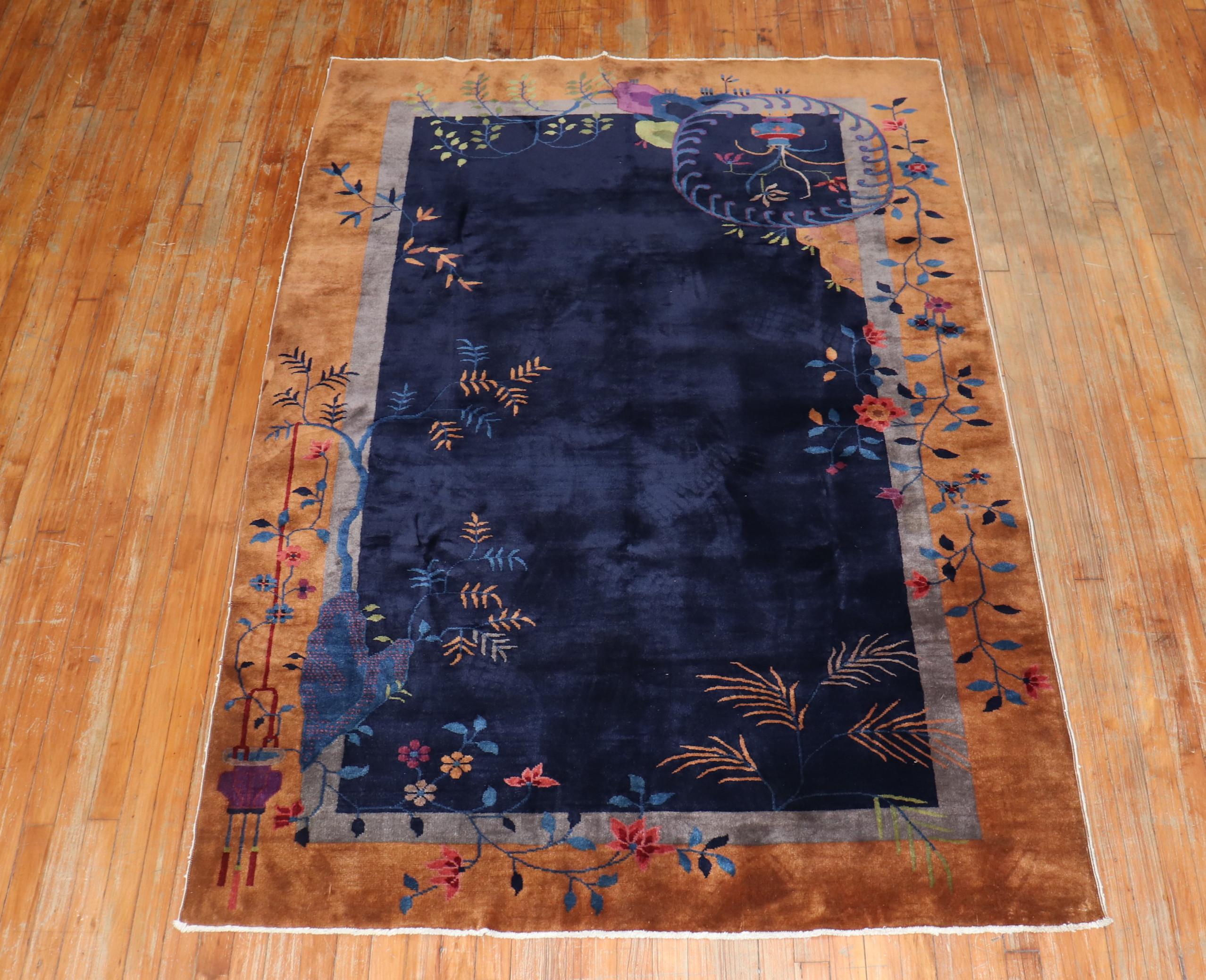 An authentic mid-20th century Chinese Art Deco with a spacious open field design in midnight blue. Art Deco rugs formats are usually found in the 3 x 5, 8 x 10, 9 x 12 size range, this one is in the 5 x 7 range. The condition on this is excellent