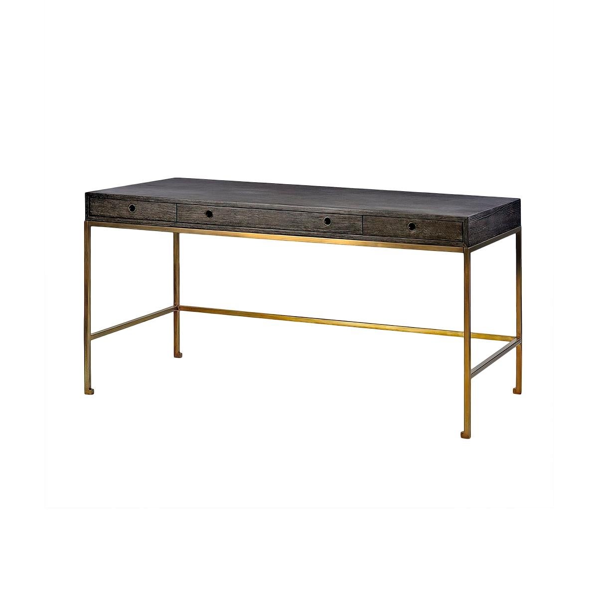Midnight Modern Desk with a unique dark cerused greyed finish having a large flat top writing surface, three drawers with metal grommet finger pulls. Raised on a bronzed finish metal base.

Dimensions: 60