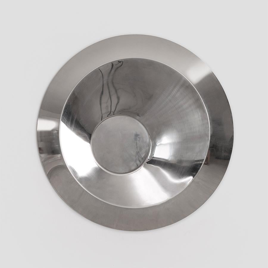 Midnight Sun explores the tension between perfect form and distorted reflection. This circular mirror is crafted from polished stainless steel with a high-gloss, “mirror” finish. The surface returns clear images while introducing subtle visual