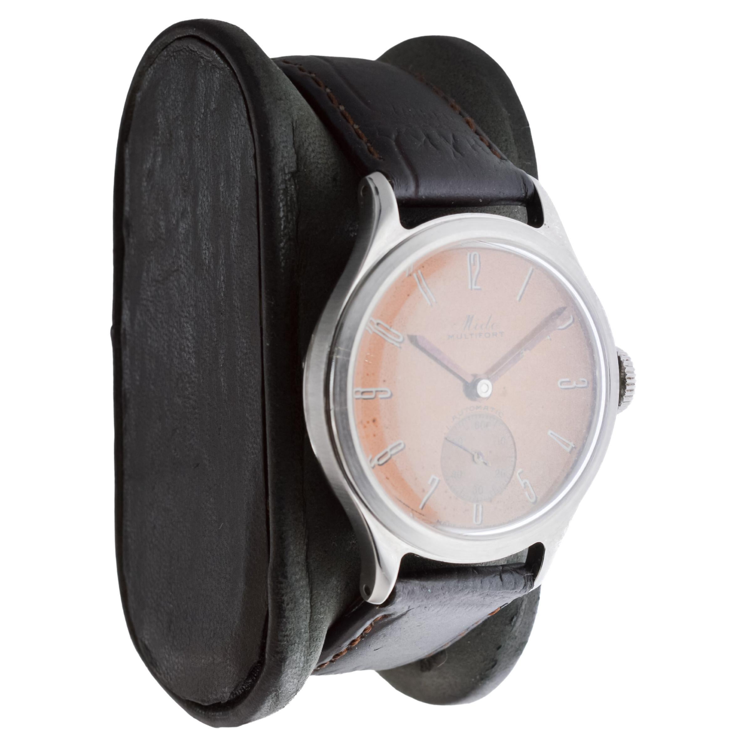 FACTORY / HOUSE: Mido Watch Company
STYLE / REFERENCE: Multifort / Reference 230
METAL / MATERIAL: Stainless Steel
CIRCA / YEAR: 1940's
DIMENSIONS / SIZE: Length 39mm X Diameter 33mm
MOVEMENT / CALIBER: Manual Winding / 17 Jewels / Caliber 
DIAL /