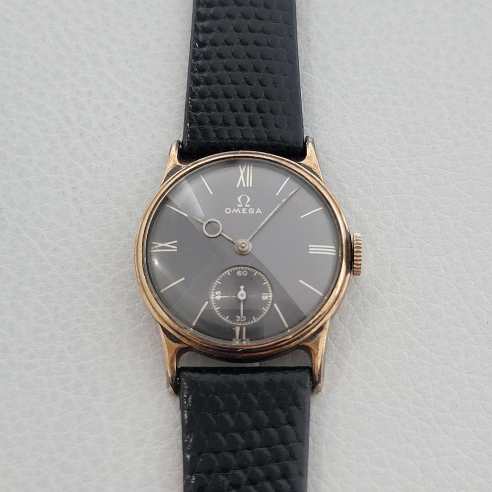 Collectable vintage classic, Men's midsize Omega 14k rose gold military style dress watch, c.1930s. Verified authentic by a master watchmaker. Gorgeous Omega signed black dial, white baton and Roman numeral hour markers, silver minute and hour