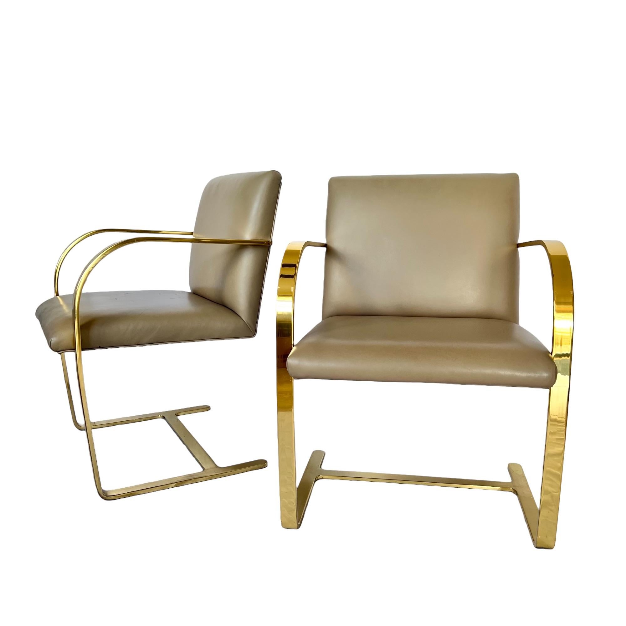 A vintage pair of Mid-Century Modern Brno flat bar armchairs designed by Ludwig Mies van der Rohe and produced by Interior Crafts. Special commission solid brass frame with taupe leather chair back & seat.

Dimensions: 23