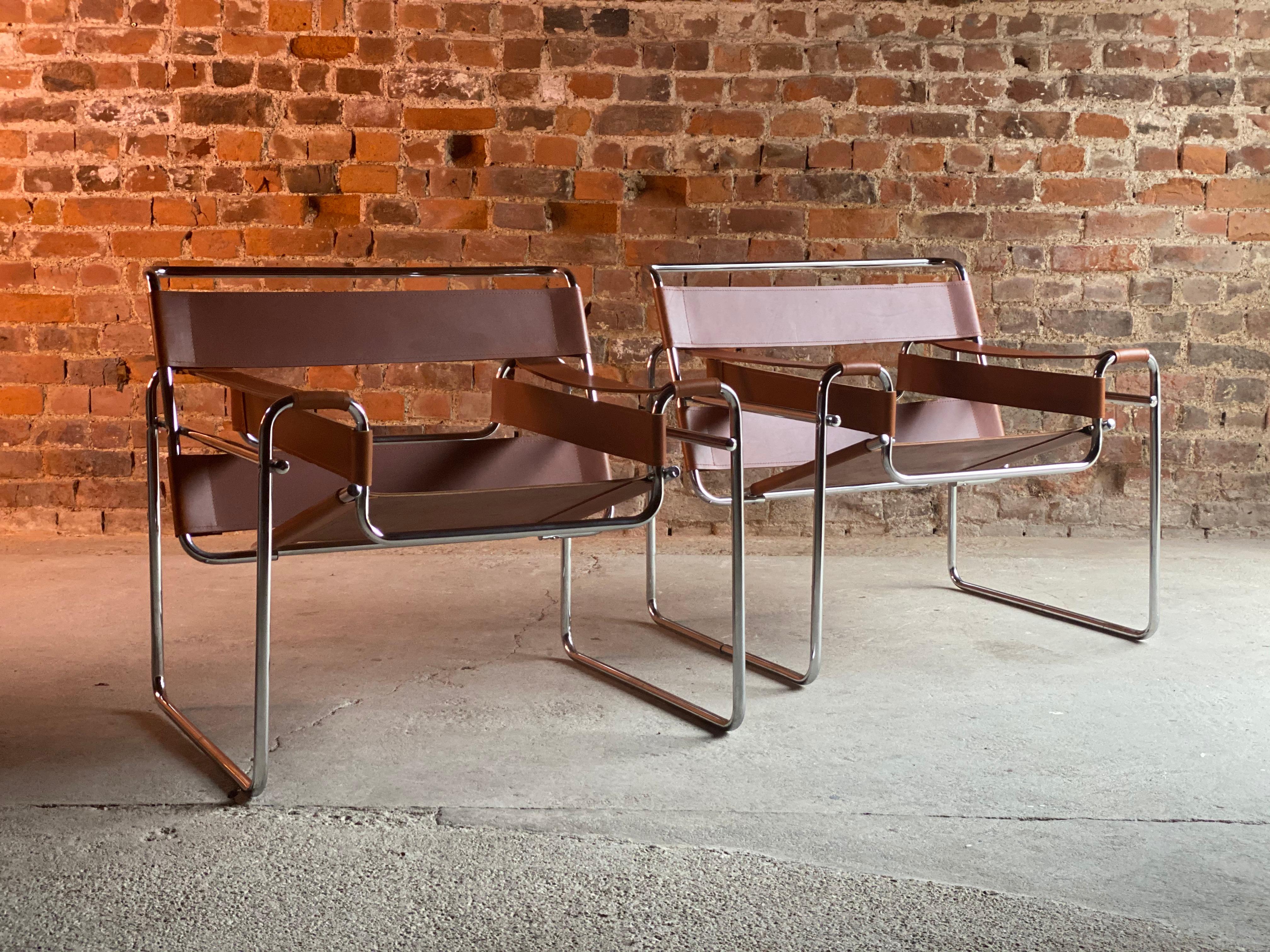 Mies van der Rohe design Wassily chairs, circa 2000

Magnificent pair of Mies van der Rohe inspired Wassily chairs, circa 2000, the chairs with tan saddle leather strapping on a chrome base. Inspired by the frame of a bicycle and influenced by the