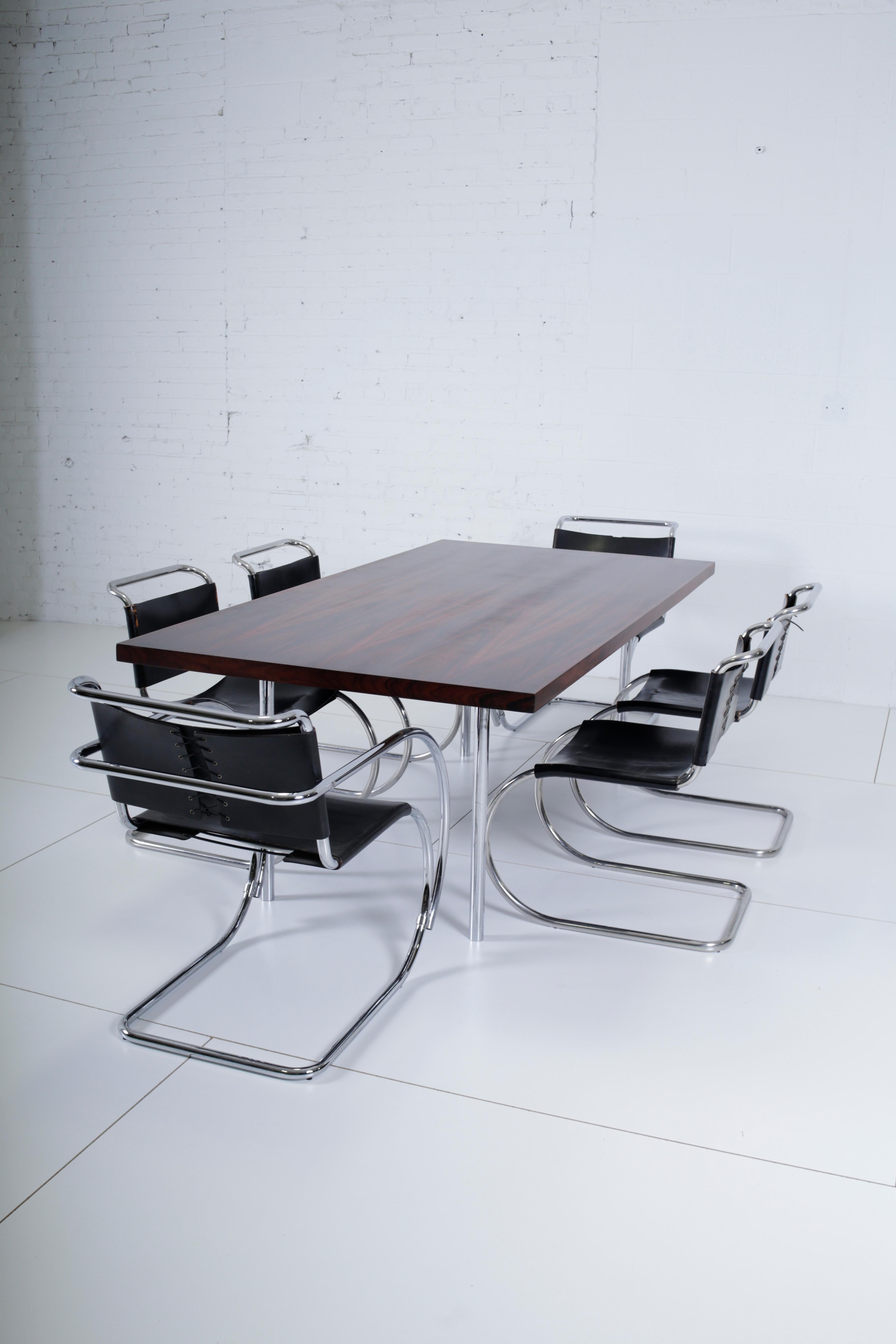 Complete Mies van der Rohe dining set, consisting of table and 6 chairs. Beautiful rosewood dining table with solid stainless steel legs, circa 1960s. Fully restored and refinished. Mies had this same table in his own home, which I have included in