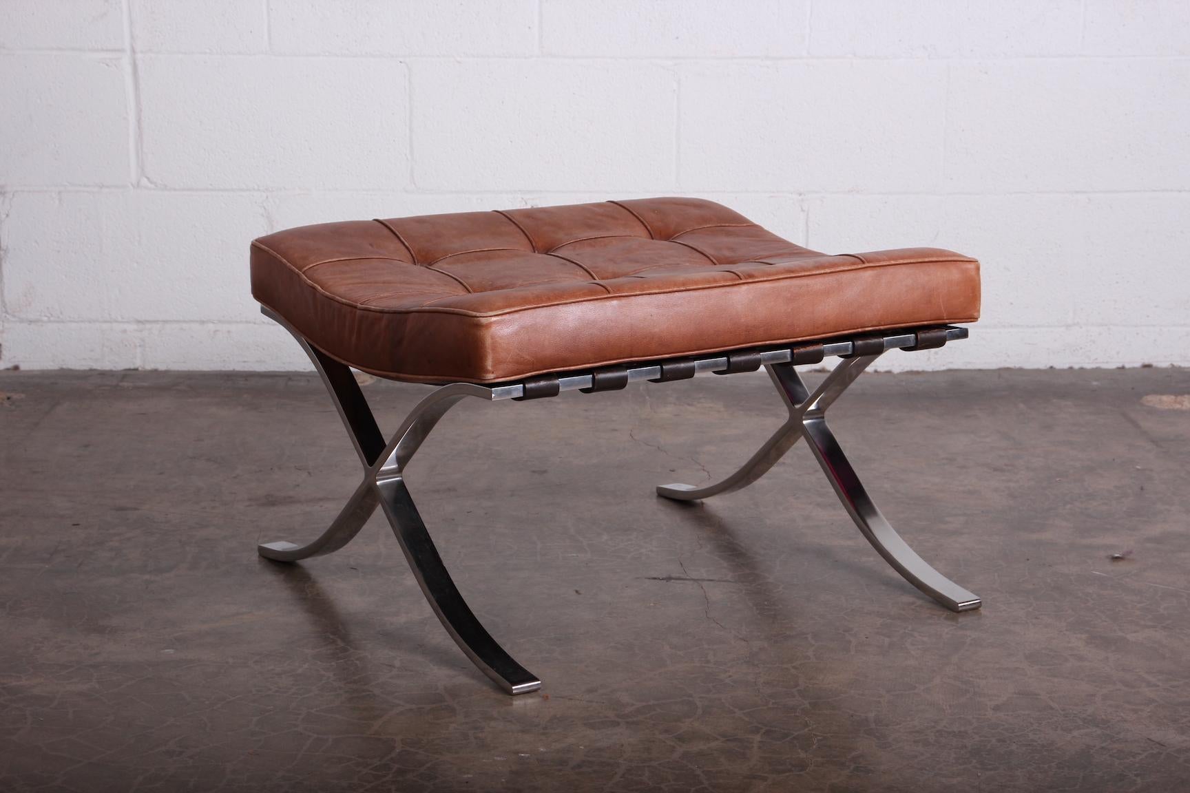 A beautifully patinated leather Barcelona stool designed by Mies van der Rohe for Knoll.
