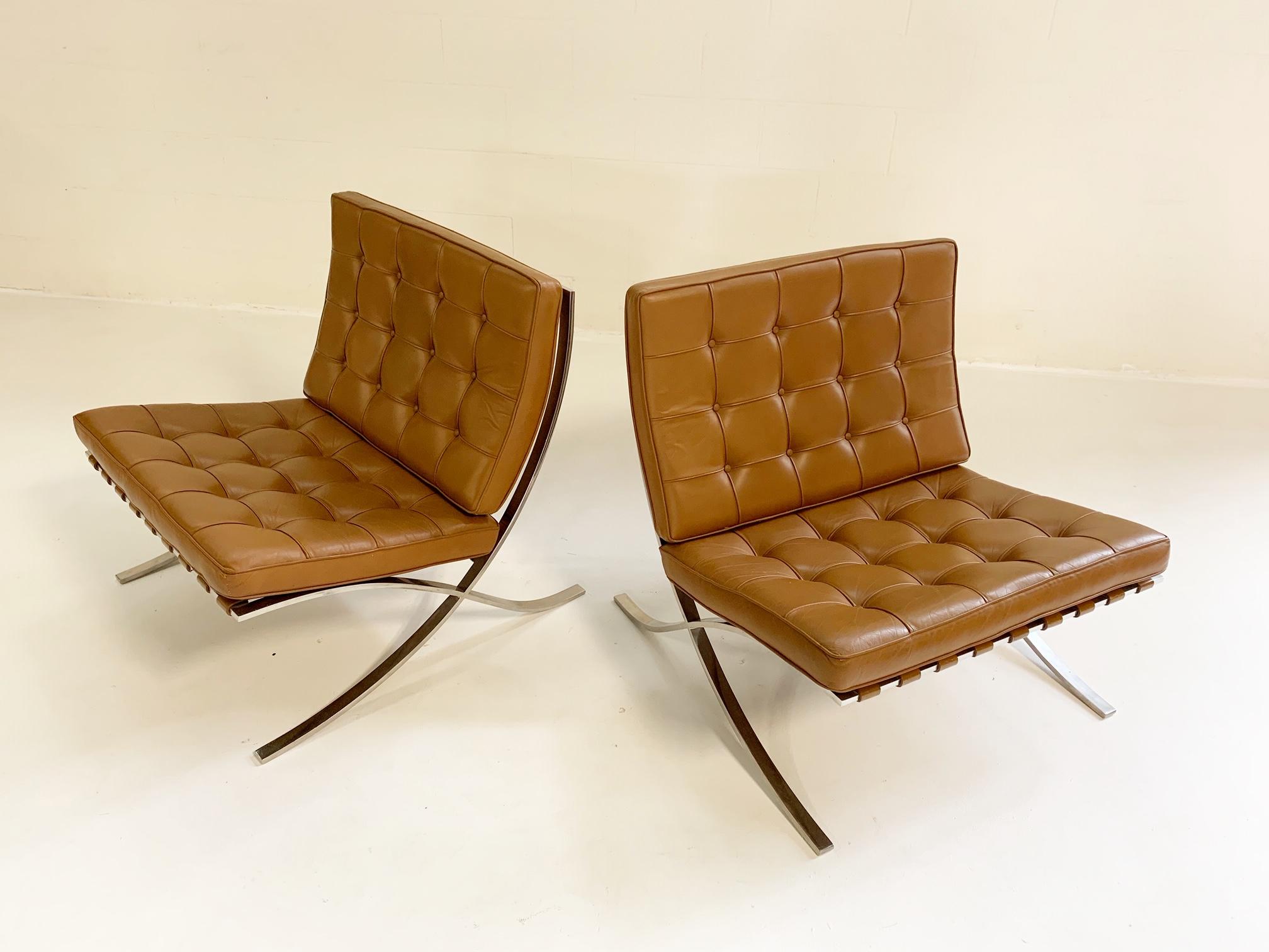 A collector's pair! These stunning pair of Barcelona chairs were made by Gerald R. Griffith under the close supervision of Mies van der Rohe. The Griffith chairs have extremely precise corners and less reinforcement at the central cross than later