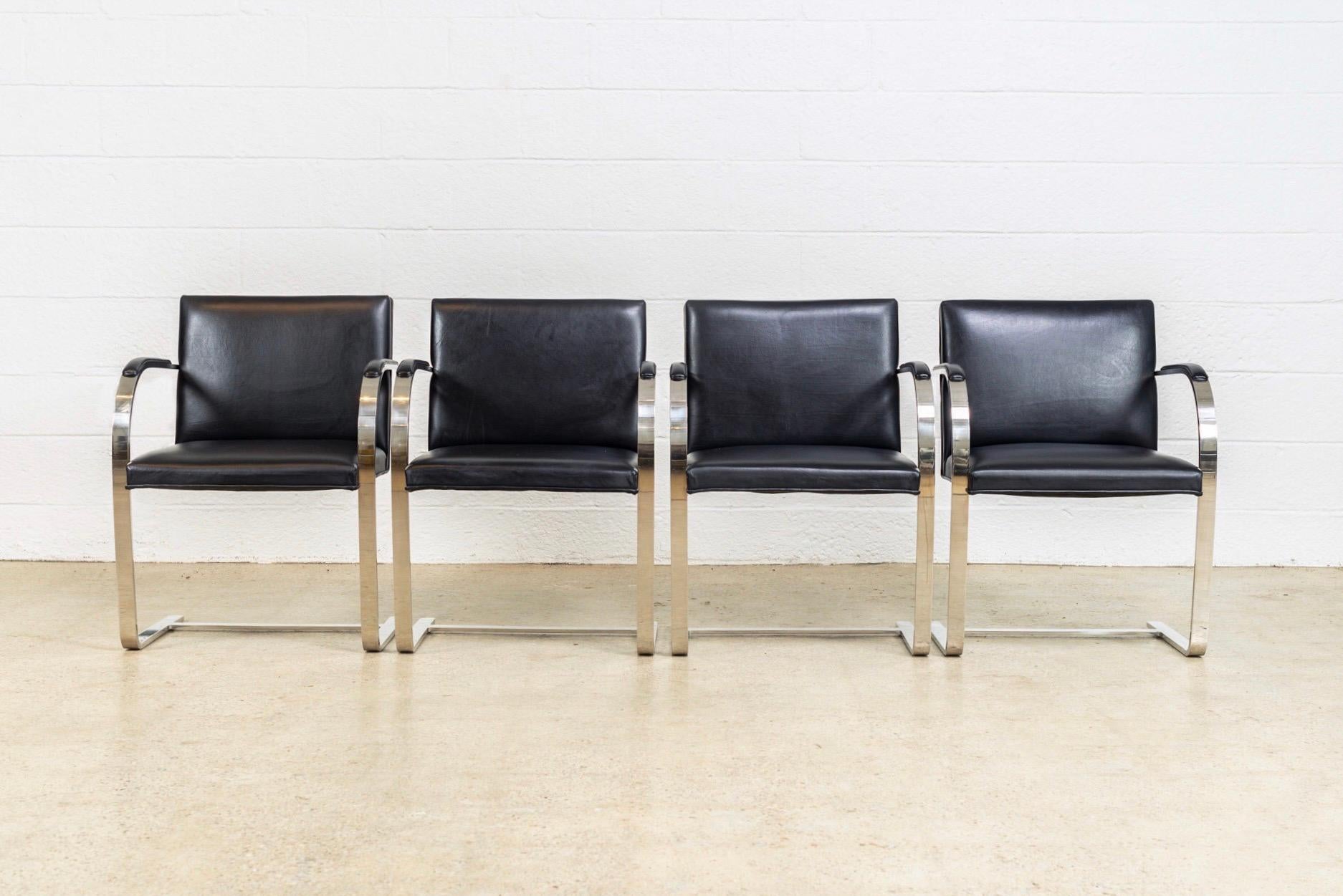 This set of four Ludwig Mies van der Rohe Brno flat bar armchairs manufactured by Knoll are, circa 1990. These iconic midcentury chairs designed by Mies van der Rohe in 1930 feature clean lines and a simple profile. This set features a steel frame