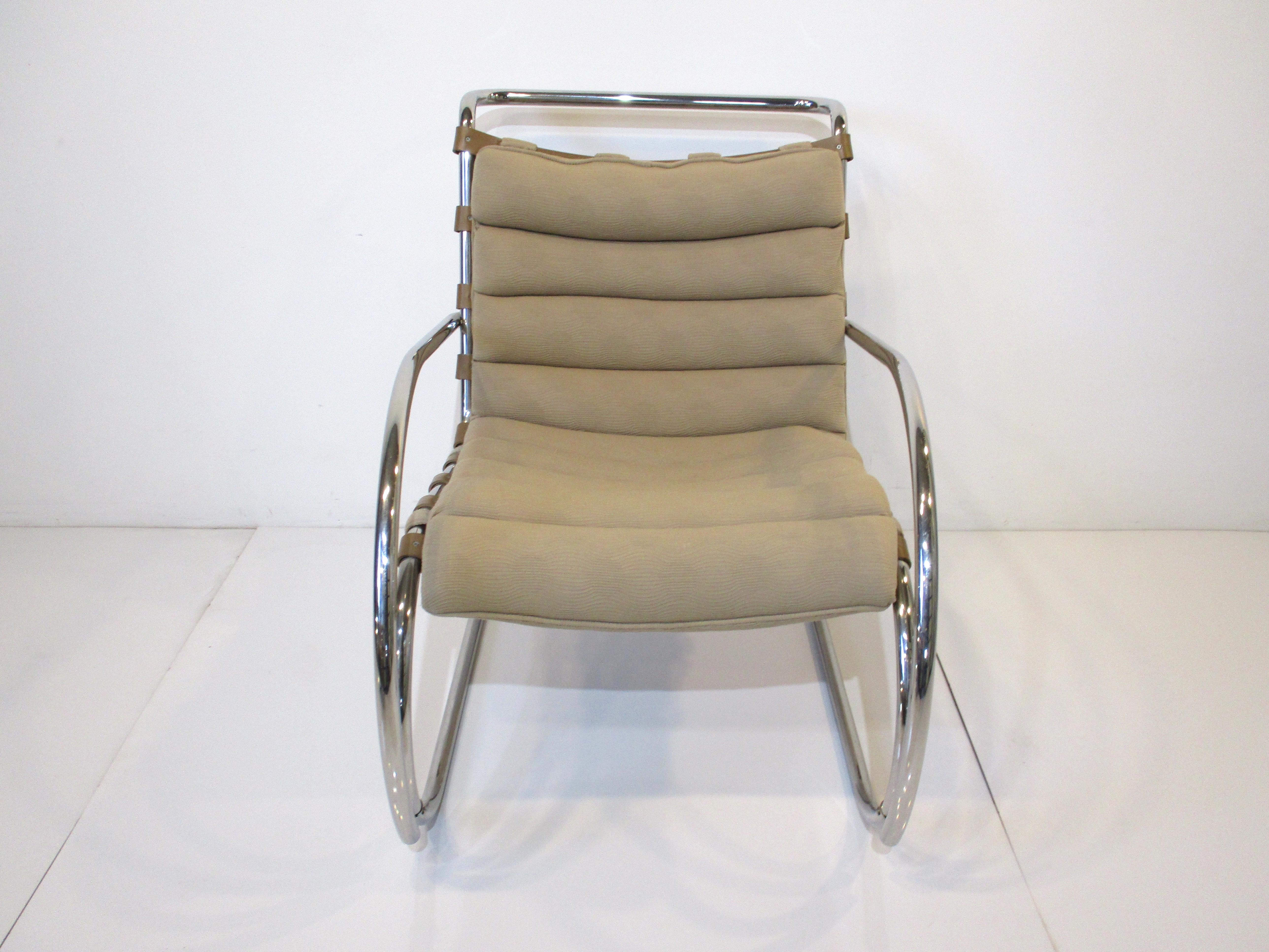 A classic in design the Beaver MR lounge chair in curved chromed tubular metal with thick leather strapping for support and rolled upholstered seat cushion . Manufactured by Knoll International , this chair is as fresh and clean in design and has