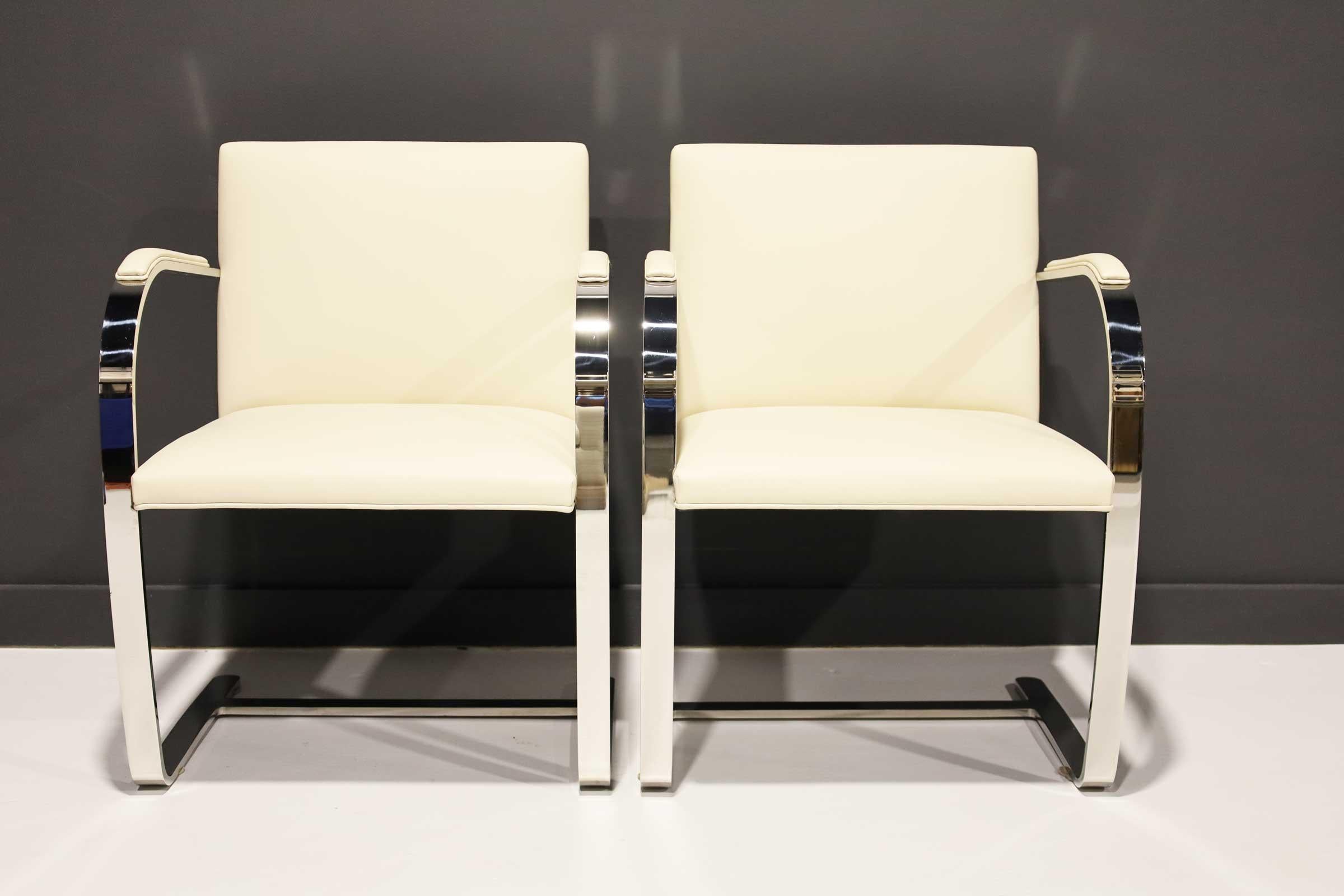The iconic Brno Chair by Mies van der Rohe for Knoll. This is a nearly new pair of chairs in high-quality off-white Acqua leather with arm pads. These are polished stainless steel as opposed to the chromed steel. Much stronger quality. These are