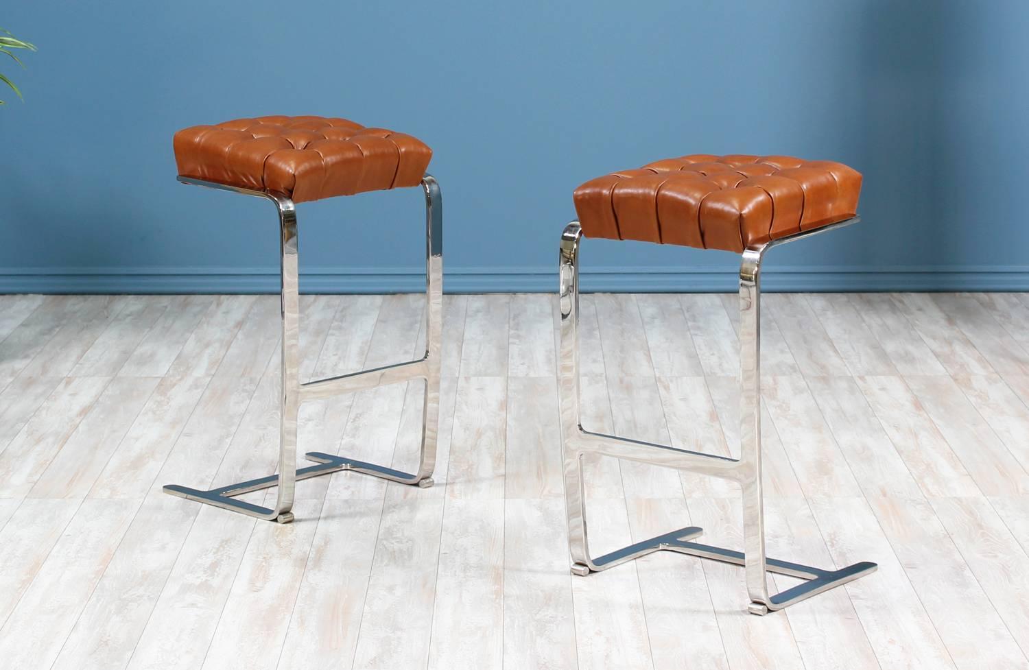 Mid Century Modern bar stools designed by Mies van der Rohe for Knoll Inc. in the United States circa 1970’s. A classy cantilevered design, featuring a bent flat steel chrome frame with a comfortable seat recently upholstered in a quality raw sienna