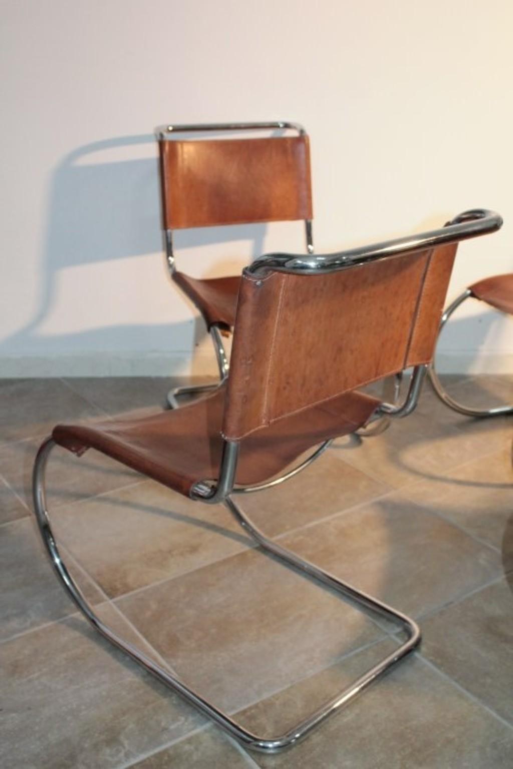 Vintage Mies van der Rohe cantilever chairs with chromed metal structures and brown leather seats. We love the spirit of Bauhaus in this design. The leather shows the signs of aging and some seams are missing.