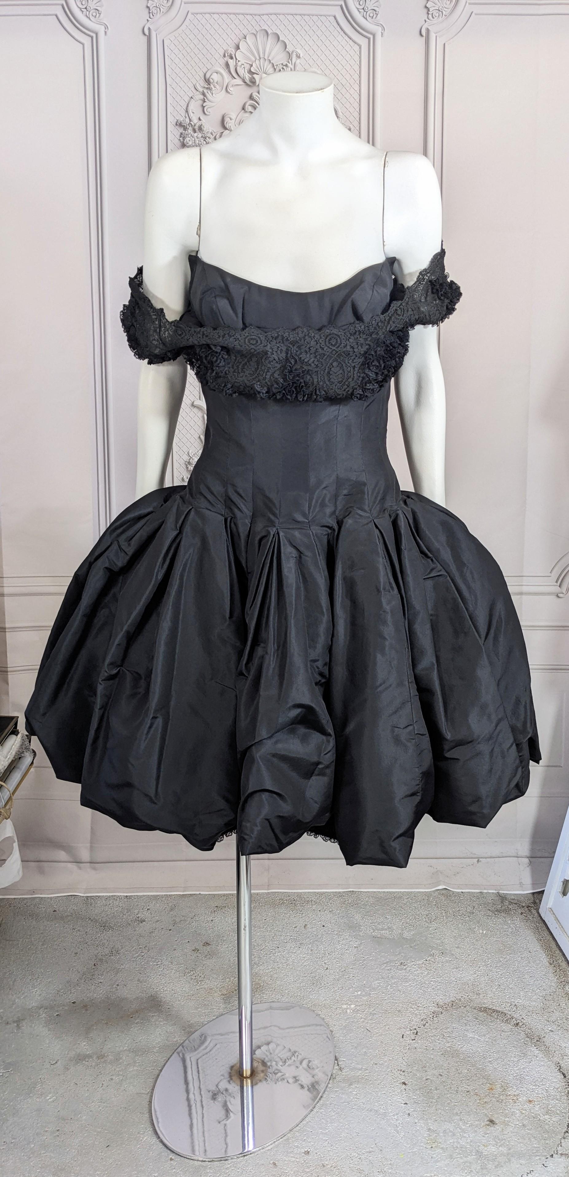 Mignon Silk Taffeta and Lace Cocktail Dress from the 1950's. Silk taffeta is tucked through the waist which opens into a full bouffant bubble skirt supported inside with tulle. Dress has a crepe base with skinny skirt trimmed in a deep hem of tiny