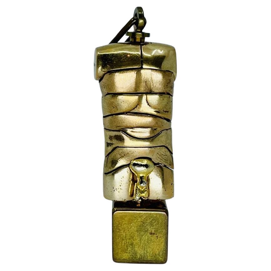 This collectible Micro-David pendant sculpture by renowned Spanish artist Miguel Berrocal showcases the perfect marriage of sculpture and wearable art. Cast in bronze with warm patina, the pendant depicts a male torso—an abstract and anatomical form