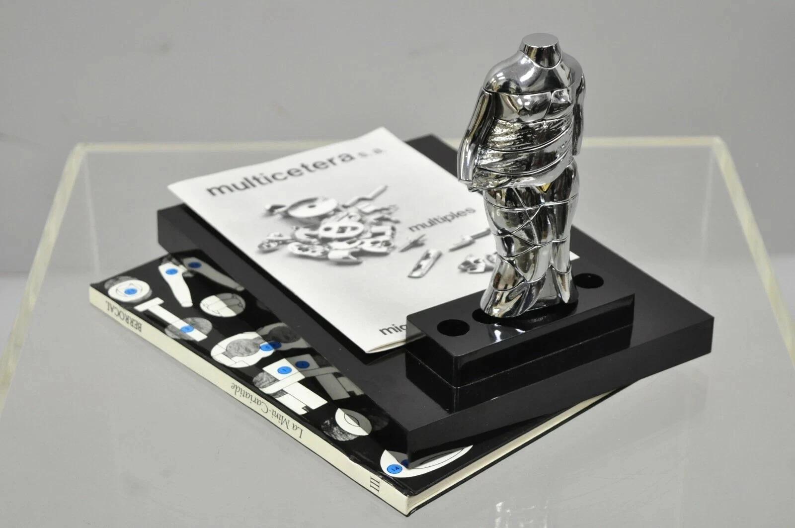 Vintage Miguel Berrocal La Mini Cariatide Nickel Plated Puzzle Sculpture in Box with Book. Circa Mid 20th Century. ***Serial number may vary. Quantity of sculptures available***. Measurements: Figure: 6