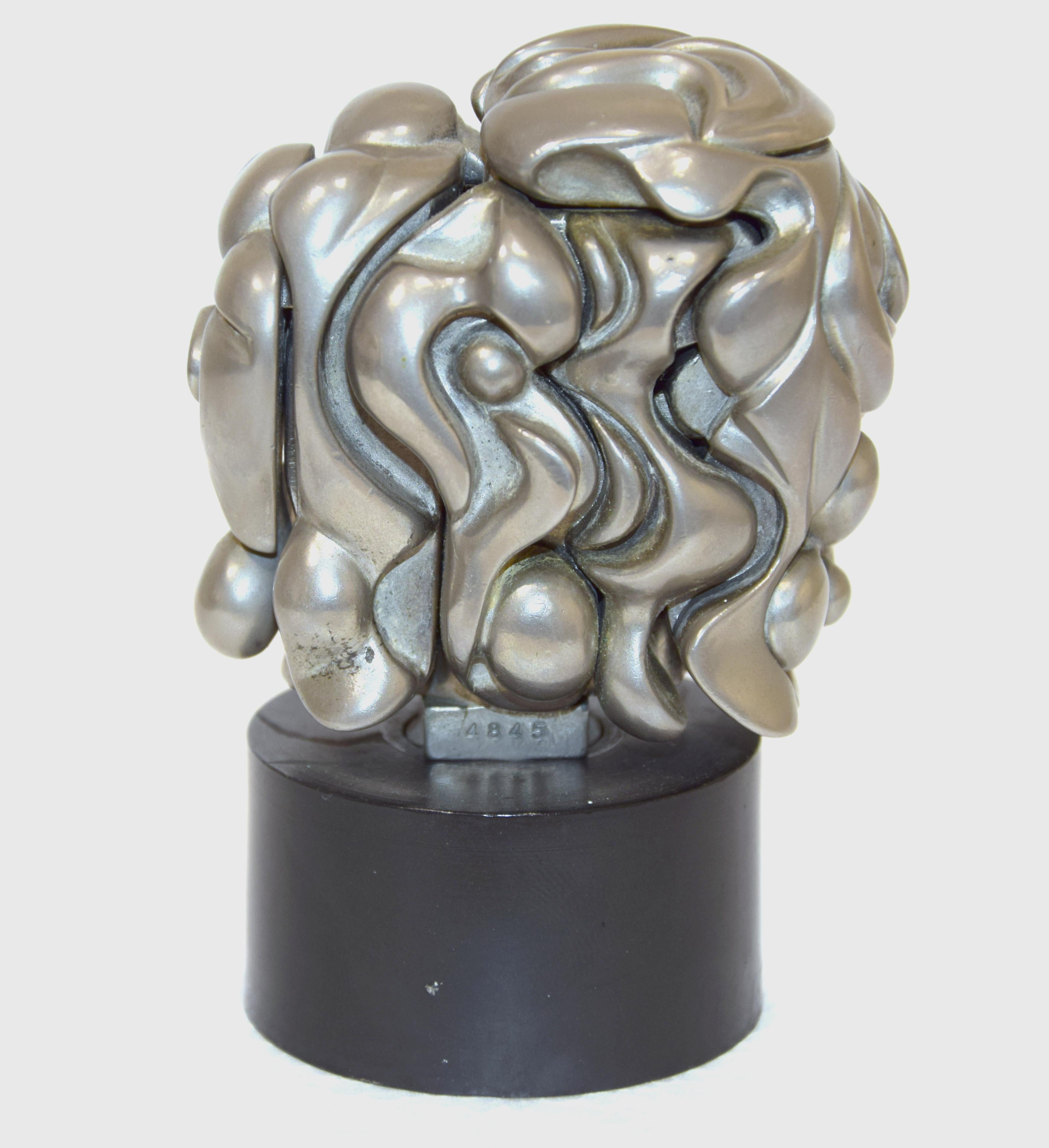 Signature and number stamped. Edition of 9500.
Nickel Plated Puzzle Sculpture with Blue Gemstone.
This fascinating mini Miguel Berrocal puzzle element sculpture of the bust of a woman called Portrait de Michele is comprised of 17 individual