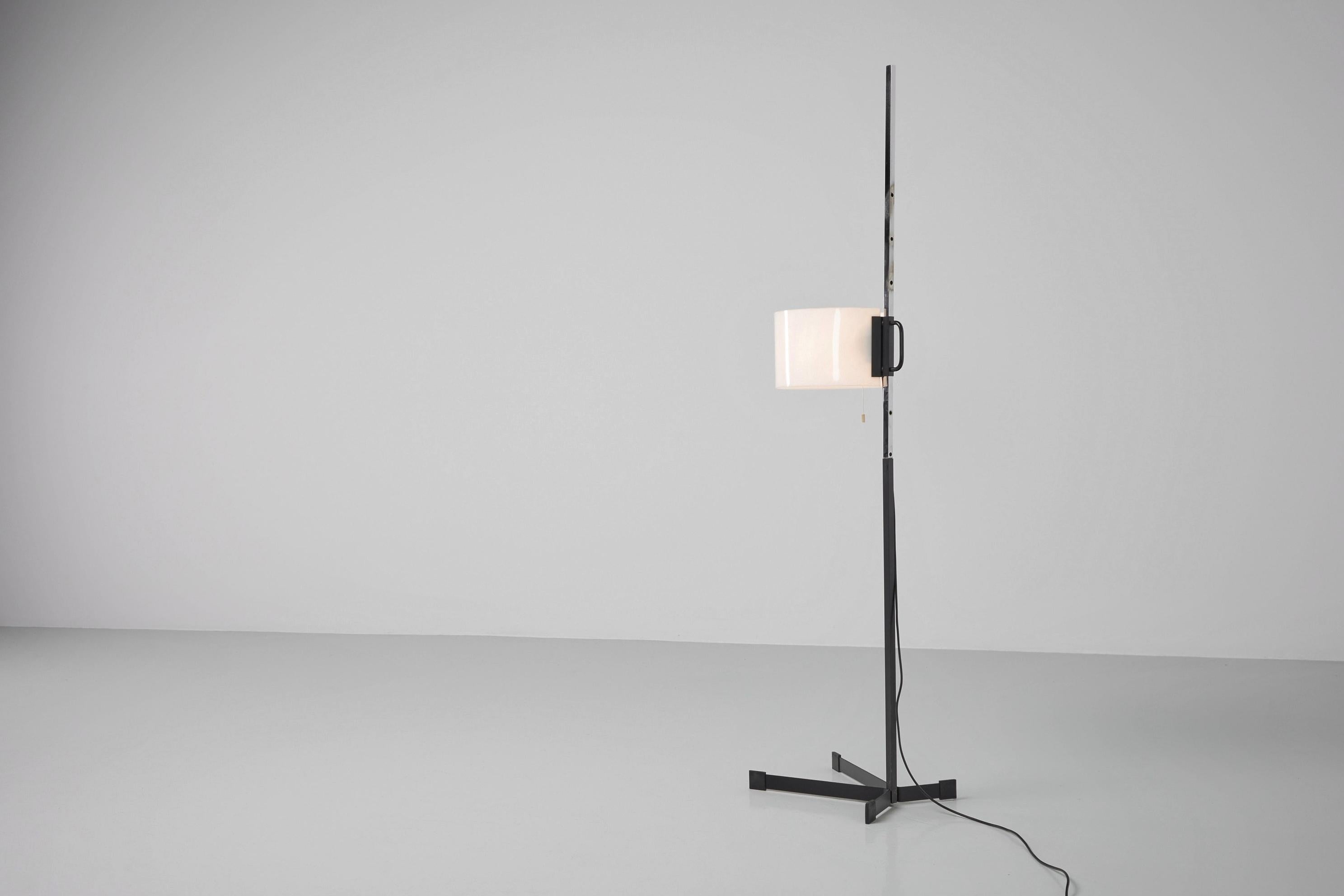 Rare floor TMC floor lamp designed by Miguel Milá and manufactured by Tramo, Spain 1950. This floor lamp is from the first production and has a very minimalistic appearance. The unusual shaped base is made of black painted metal, it has an