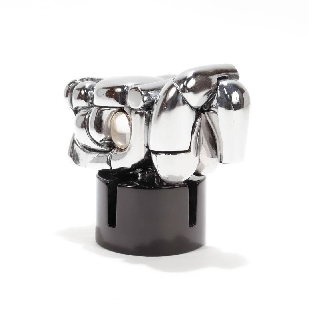 A fine boxed, modernist Mini Maria puzzle sculpture by Miguel Ortiz Berrocal.

In nickel-plated bronze.

Together with its original box, wrapping paper, styrofoam, paperwork and documents, and other contents. 

Originally cast in 1980.

The reverse