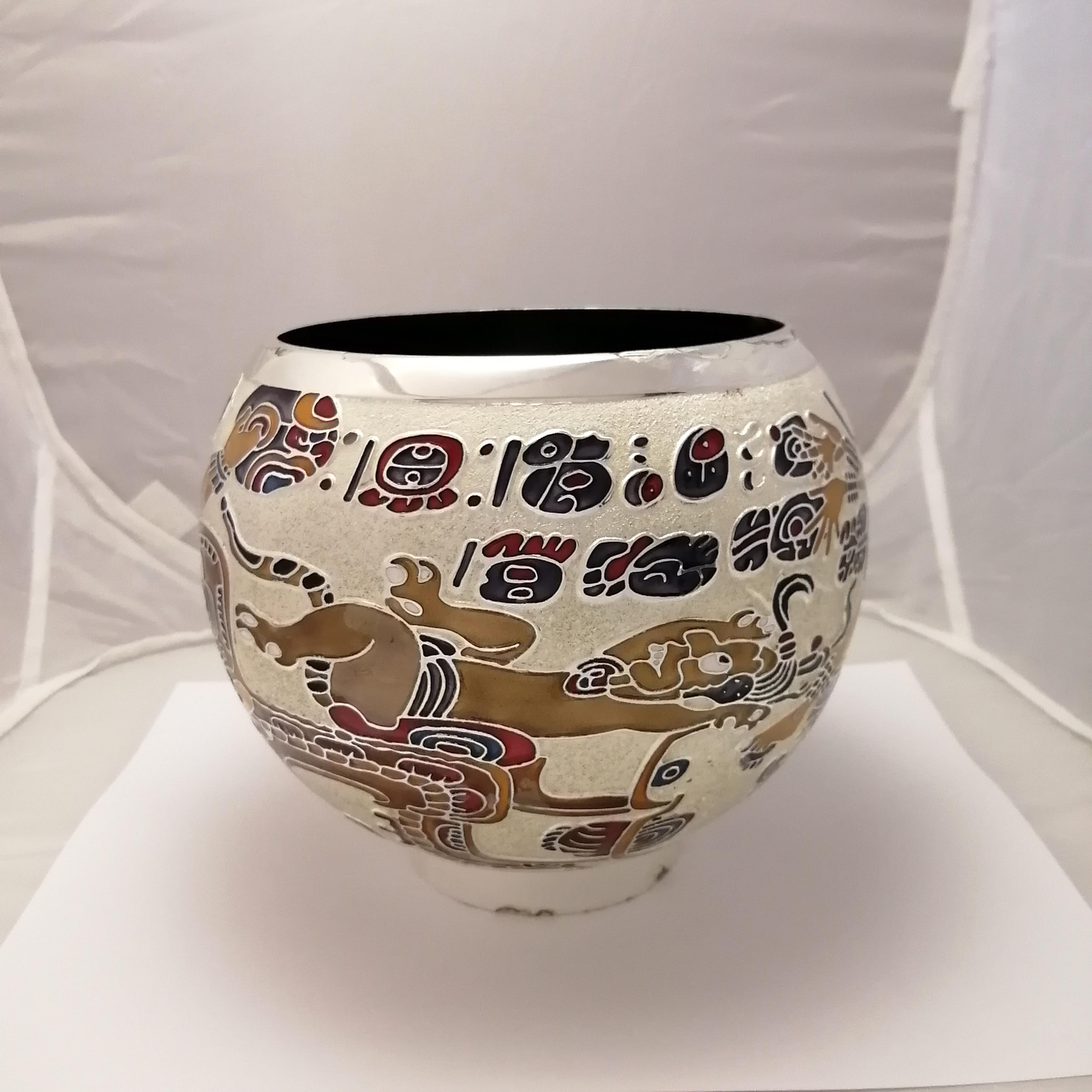 A fine 1970s Mexican Mid-Century Modern silver plate with enamel vase by Mexican designer Miguel Pineda. The multi-color enamel shows a Mayan sacrifice scene with fantastic creatures and glyphs over a white sandblasted background. Interior and base