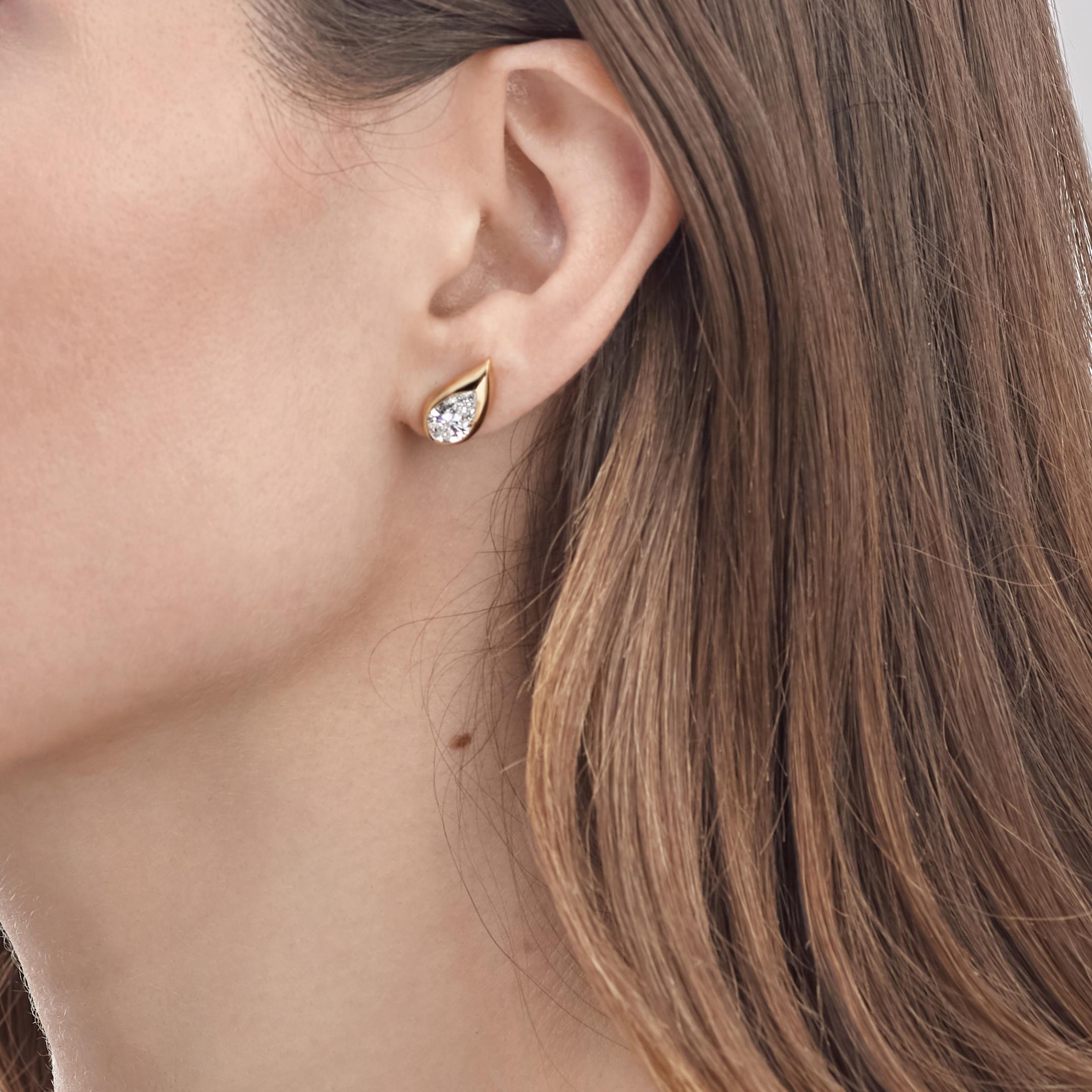 Jewels Aficionado offers this sculptural yellow gold earring introduces a fresh and refined element to you ear stack. Inspired by elements of the earth, The Mika Earring features a pear shaped diamond set in 18K yellow gold and sculpted into a