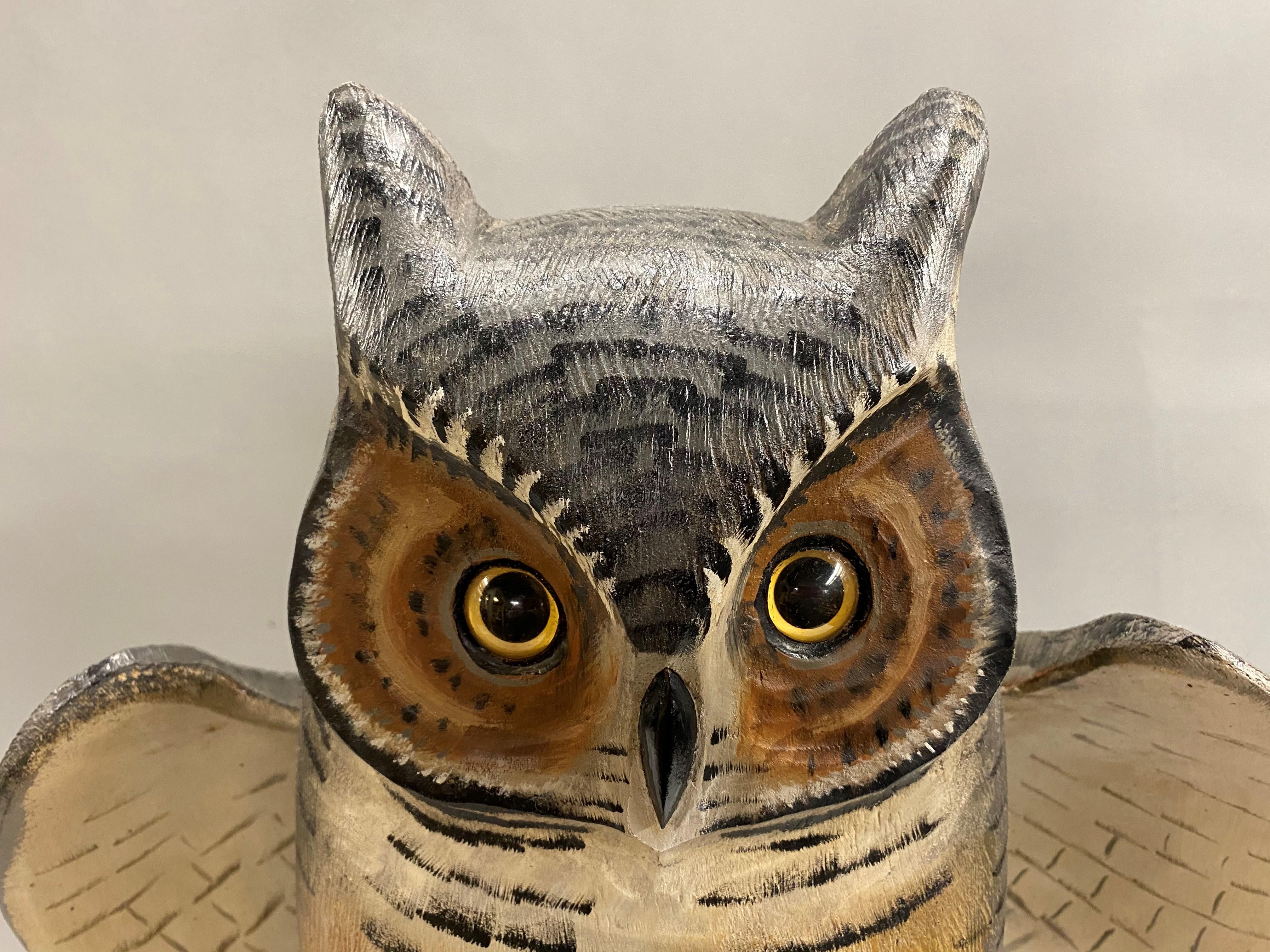 A splendid polychrome carved wooden great horned owl with hinged wings by American artist Mike Borrett (b. 1960). Borrett is a well known decoy carver from Madison, Wisconsin. This carved Great horned owl has glass eyes, nicely painted detail, and