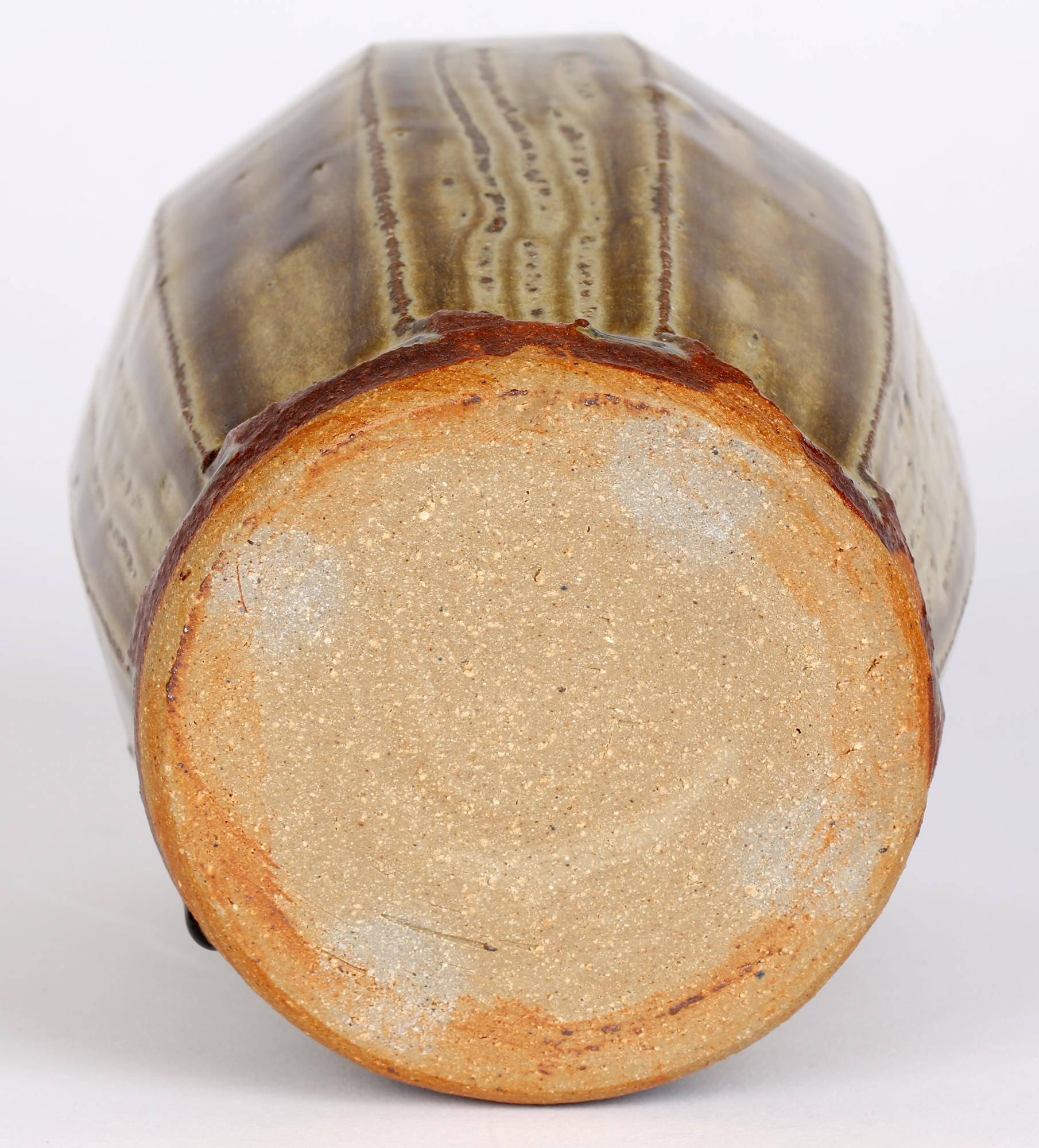 Mike Dodd (Brite, geb. 1943) Studio-Keramikvase mit facettiertem Korpus und grüner Schleppglasur aus dem 20. Jahrhundert. Die Steingutvase steht auf einem unglasierten Fuß mit einem messerscharfen Gratabschluss am unteren Ende jeder Facette, in dem