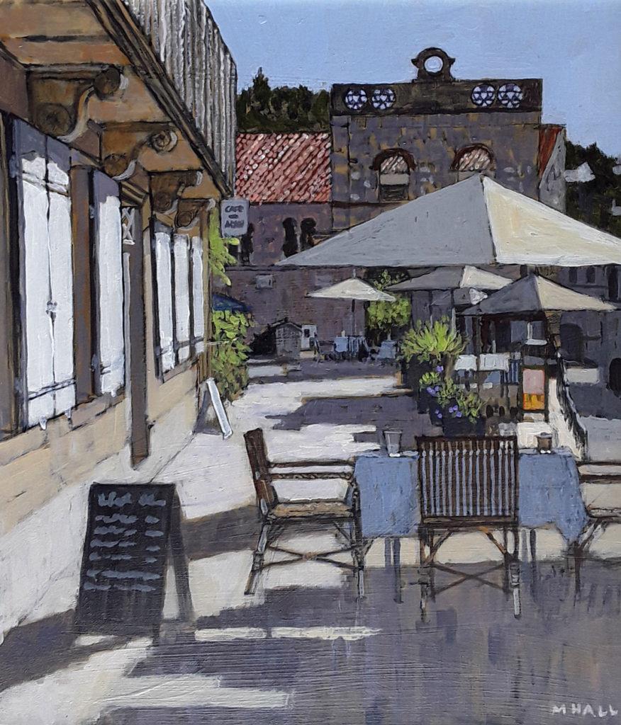Mike Hall Landscape Painting - Table set for Lunch, Dordogne - sunset view French cafe white umbrella acrylic 