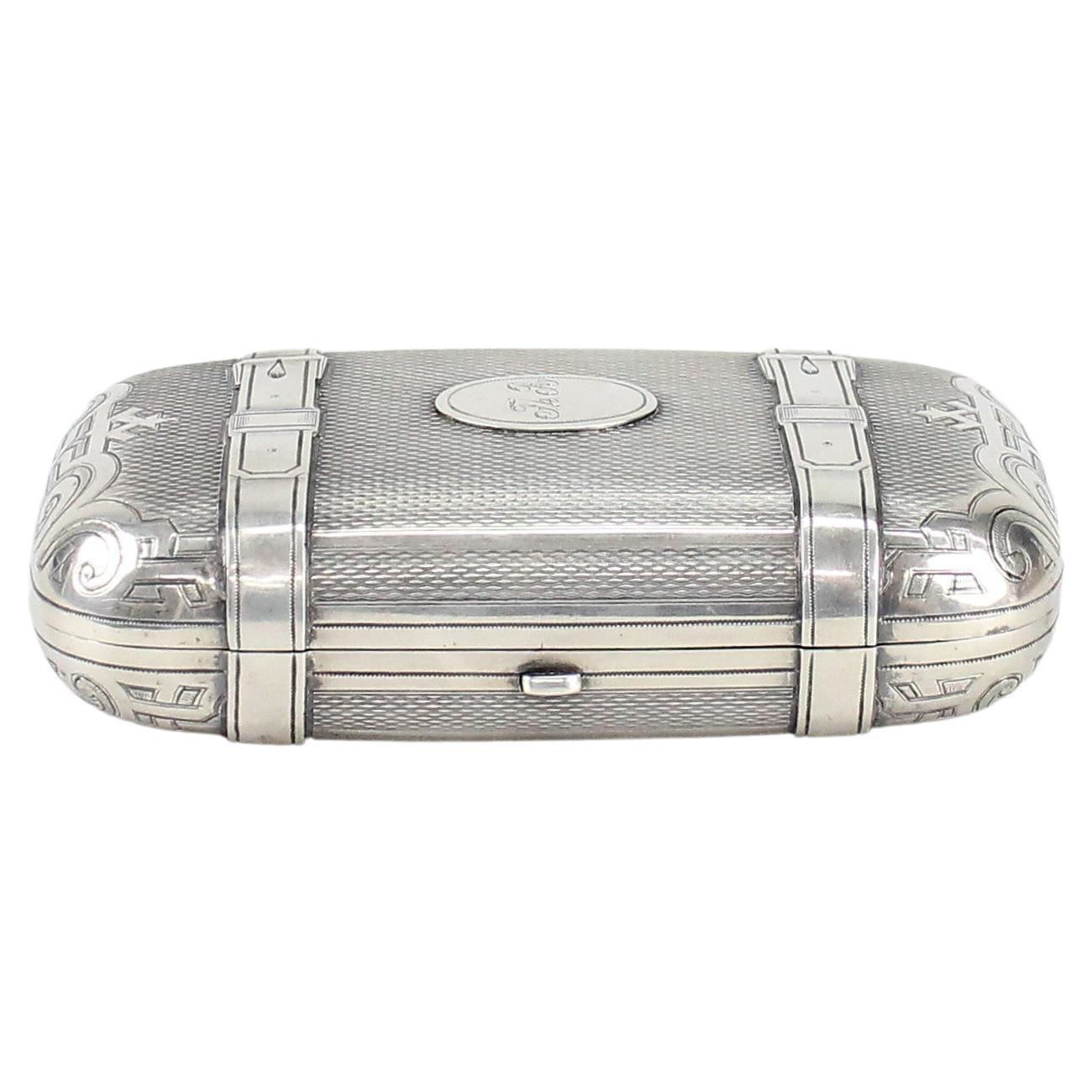 Mikhail Yakovlevich Isakov, St Petersburg.
A Russian trompe l'oil silver cigar case in the form of a suitcase.
Hallmarked twice, for Russian silver 84 and makers marks.

Late 19th century. The case is engraved '1893'.
High-quality work.
Really