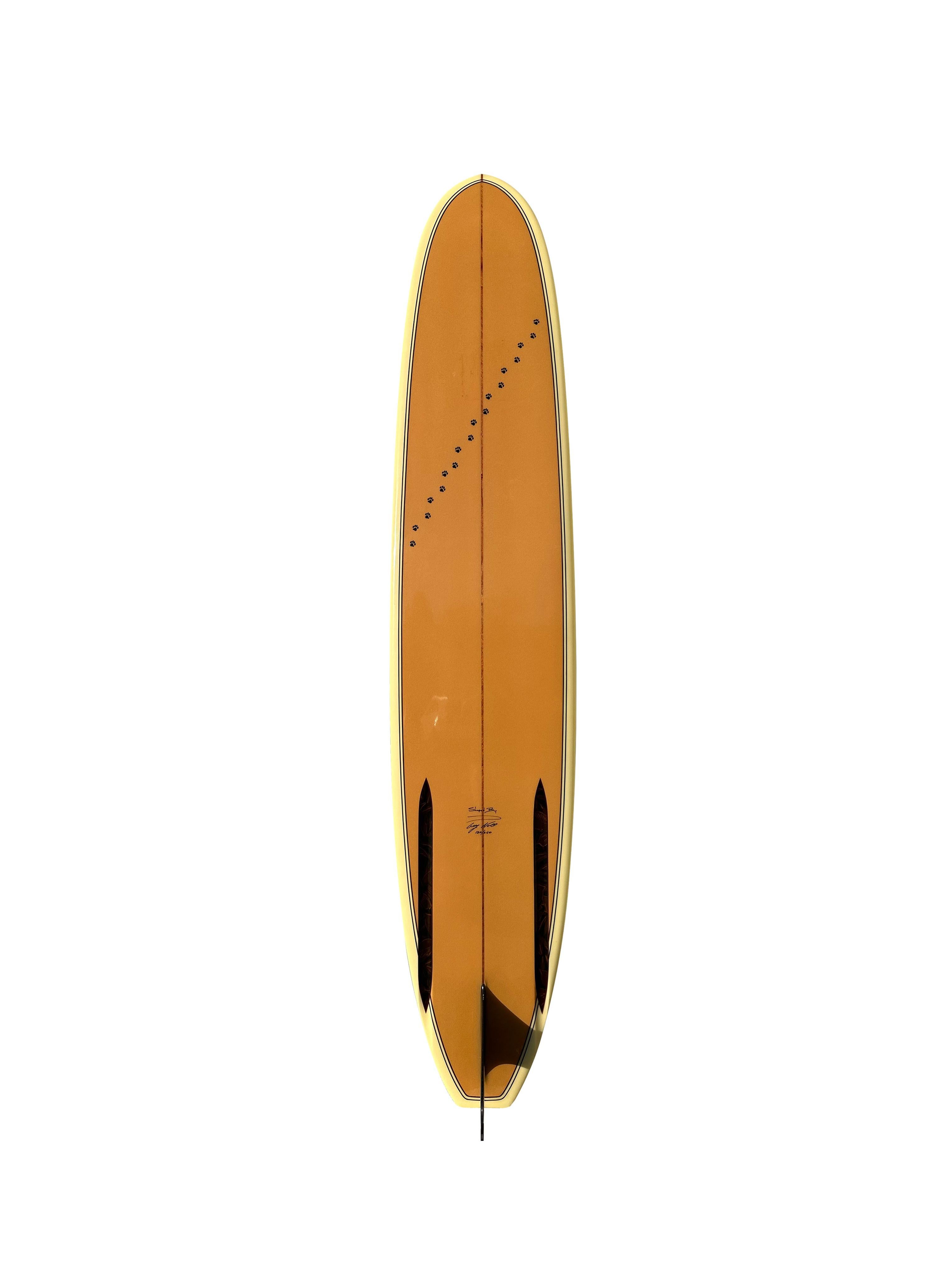 Greg Noll Mickey Dora “Da Cat” model limited edition longboard shaped in 1998. Serial #120/250. Featuring a gorgeous Hawaiian coffee color floral patterned nose reveal, with matching print on bottom channels and classic double pinstriped outline.