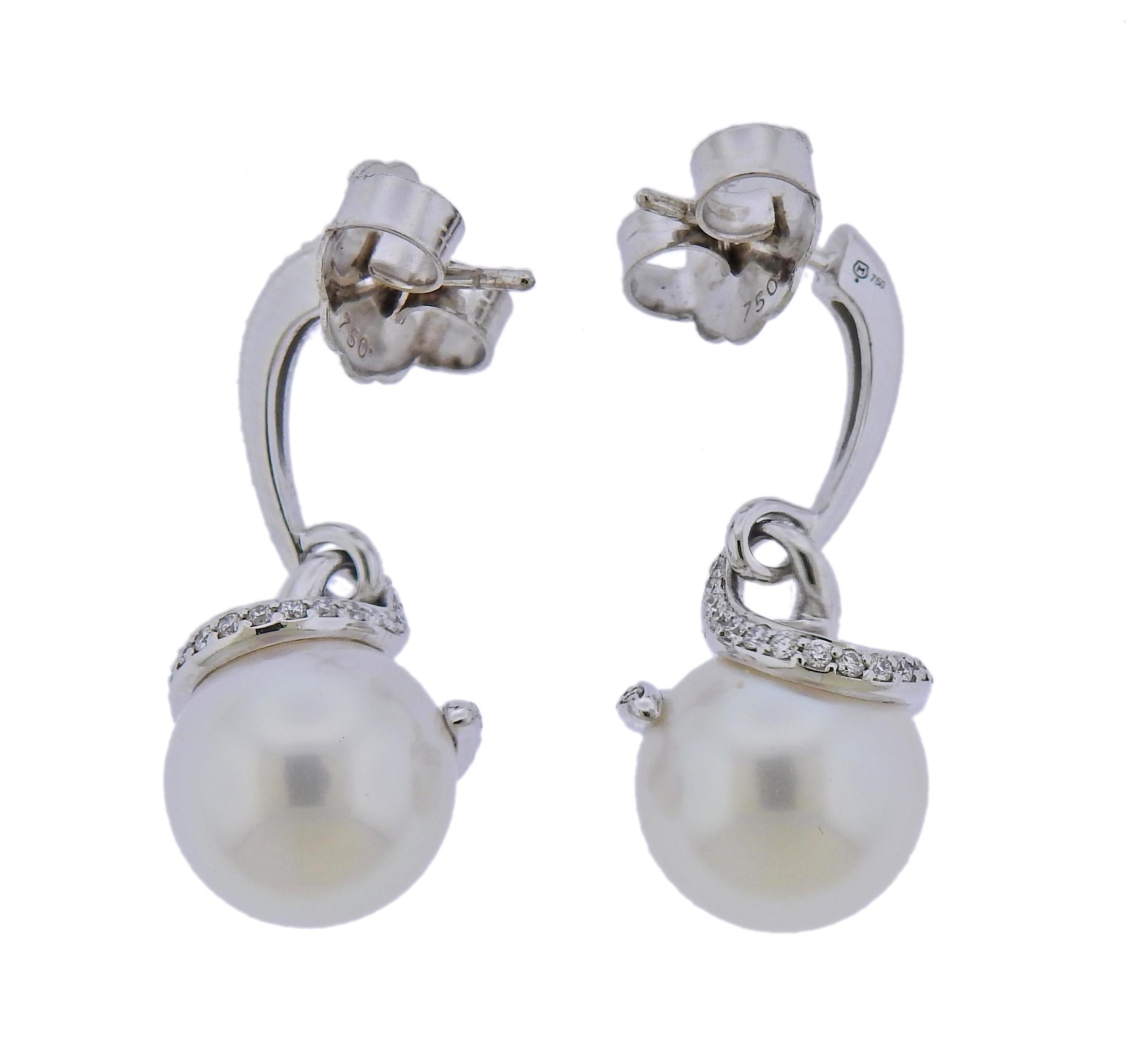 Pair of new 18k white gold twist earrings by Mikimoto, set with A+ 11mm South Sea pearls and approx. 0.45ctw G/VS diamonds. Retail $11000. Come with box and warranty. Earrings are 29mm long. Weight - 10.3 grams. Marked: M mark 750. 