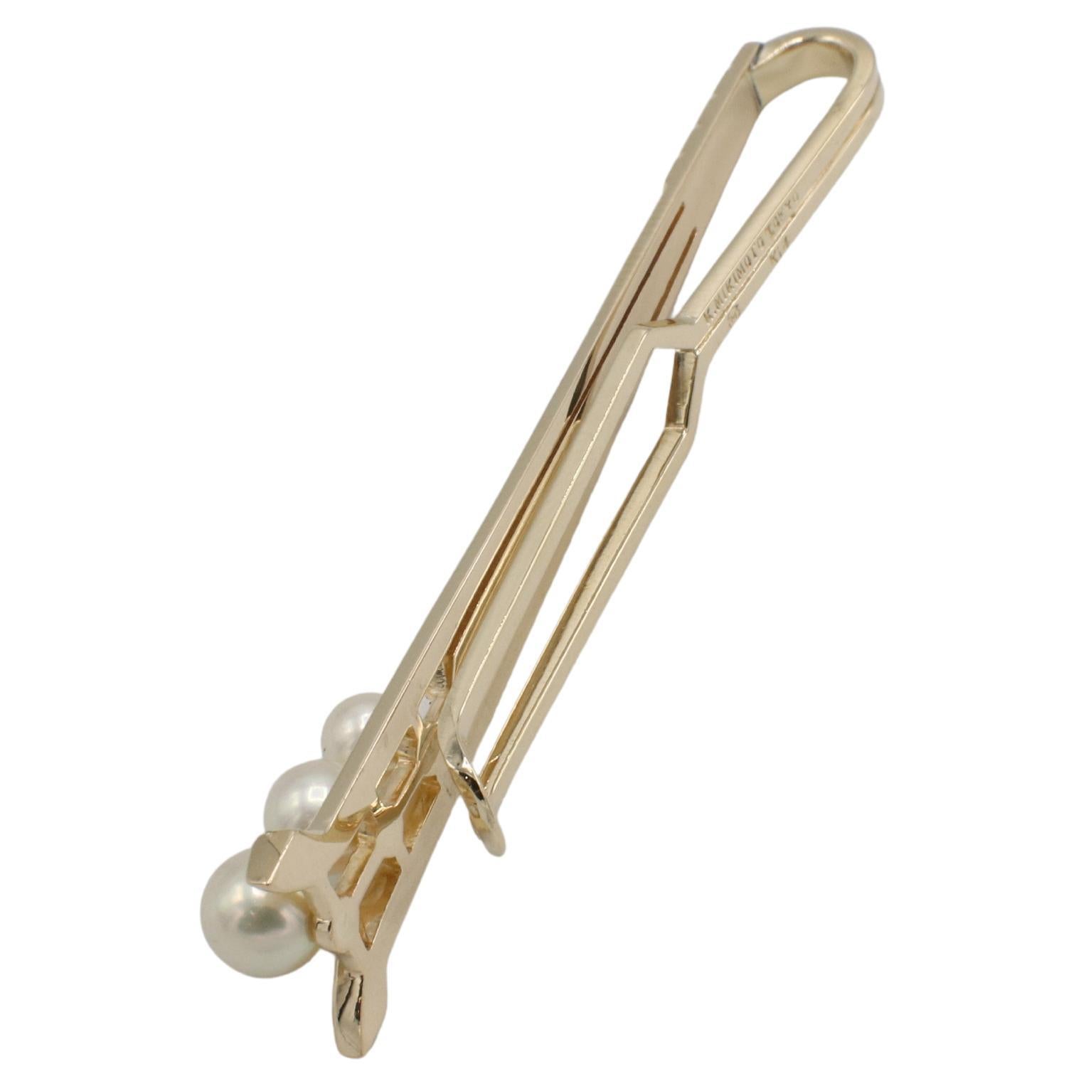 Mikimoto 14 Karat Yellow Gold Akoya Pearl Tie Bar Clip Pin 
Metal: 14k yellow gold
Weight: 7.36 grams
Pearls: 3 cultured Akoya white pearls, 4,5 - 5.5mm
Length: 2.30 inches
Width: 12mm
TDD F35000211