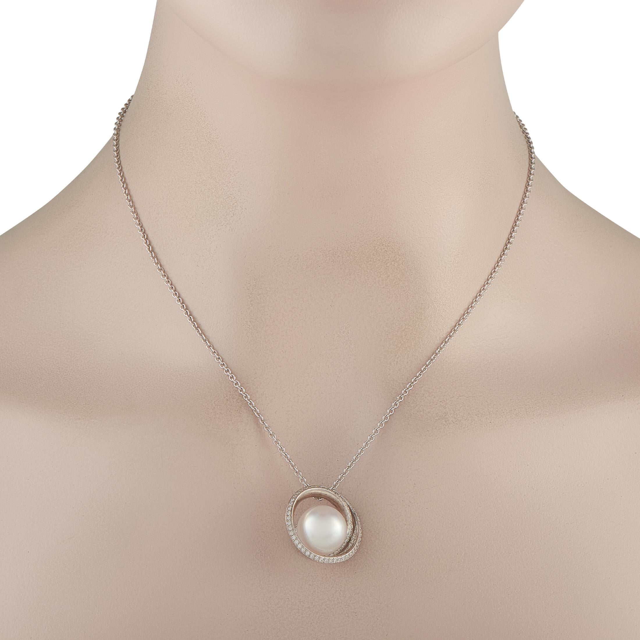 This captivating Mikimoto necklace features a stunning sense of movement. On this piece, a curved 18K White Gold pendant measuring 1.0 long by 0.88 wide is suspended from a 16 chain. A singular 13.5mm Pearl makes a statement in the center, while