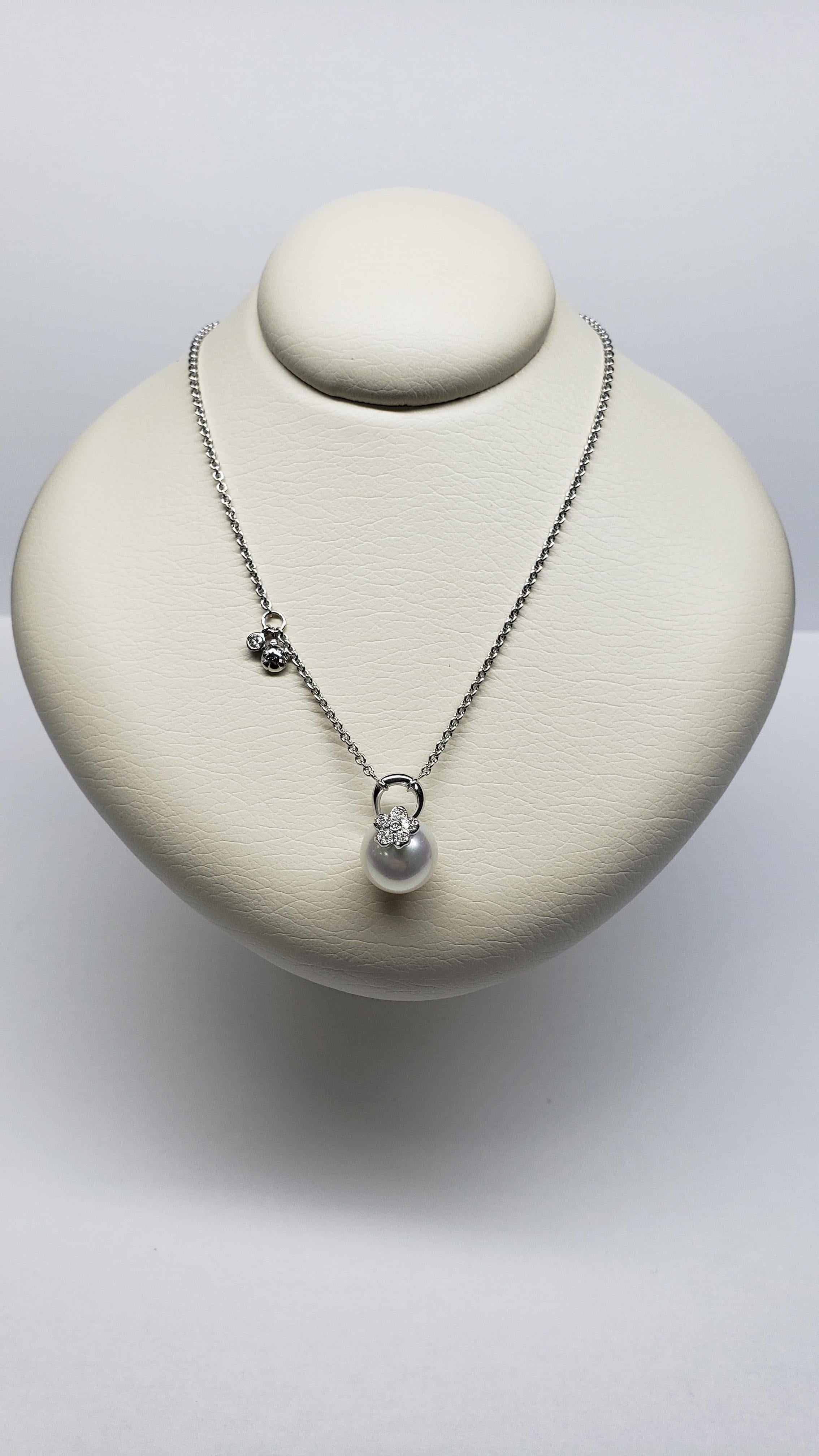 This Mikimoto, 18K, White Gold, 11mm, White South Sea Pearl, Flower Pendant features an A+ quality, cultured south sea pearl. It is adorned with an 18K white gold and diamond flower designed bale. Attached is a 16