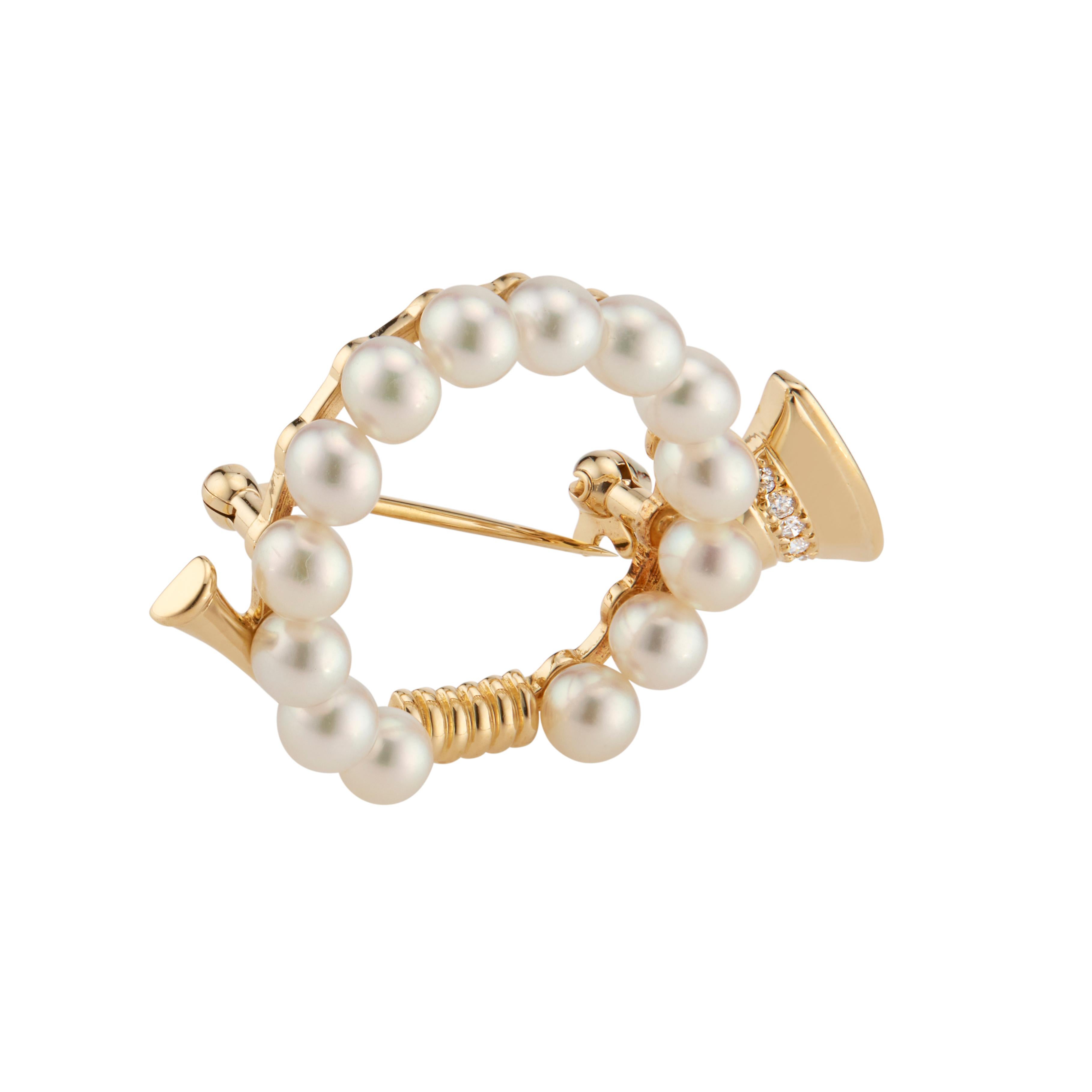 Authentic 18k Mikimoto French Horn Brooch. 14 round Akoya Pearls are Mikimoto’s set in 18k yellow gold with 5 round accent diamonds. 

 5 round diamonds approx. total weight .05cts, F, VS. 
14 round cultured Akoya pearls 4.5mm. 
18k yellow gold