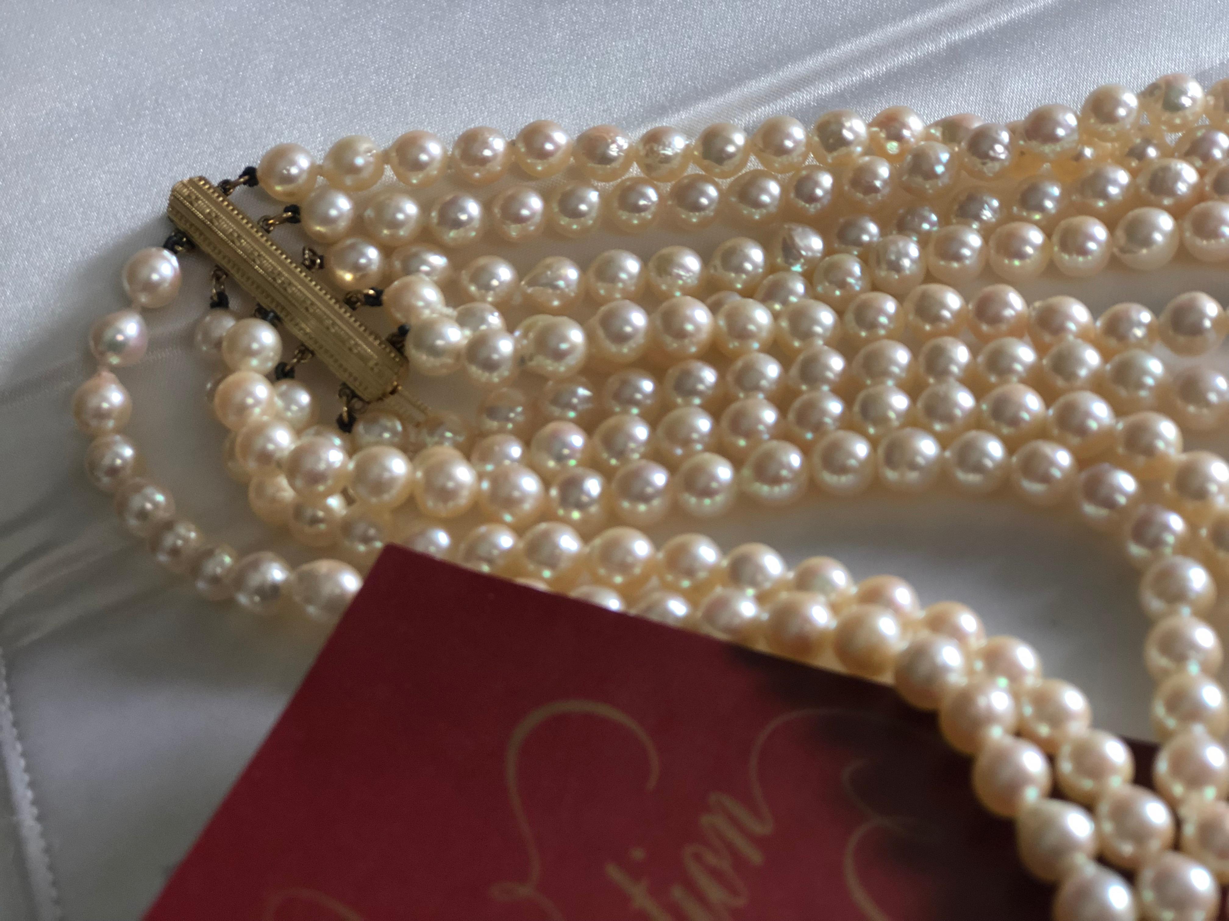 Very elegant five strand neckless of 7 mm. white pearls by Mikimoto, resting in the original box. 
Great condition.
Japan, circa 1950
