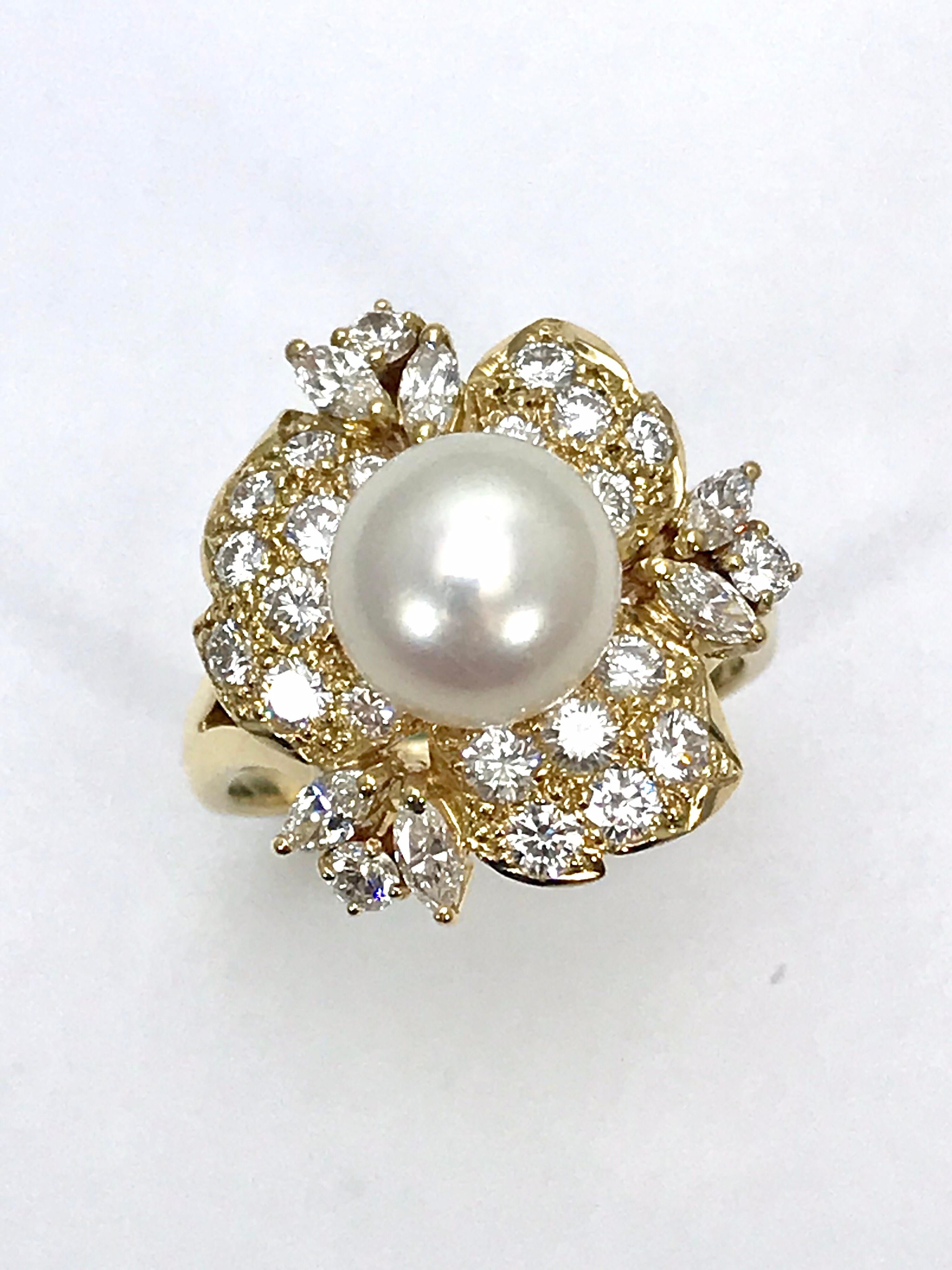 This is an elegantly ring.  Designed by Mikimoto, the 9.00 millimeter Cultured Pearl sits atop a floral Diamond cluster set in 18 karat yellow gold.  The Diamonds are made up of mainly round brilliant Diamonds, with six marquise shapes on the outer