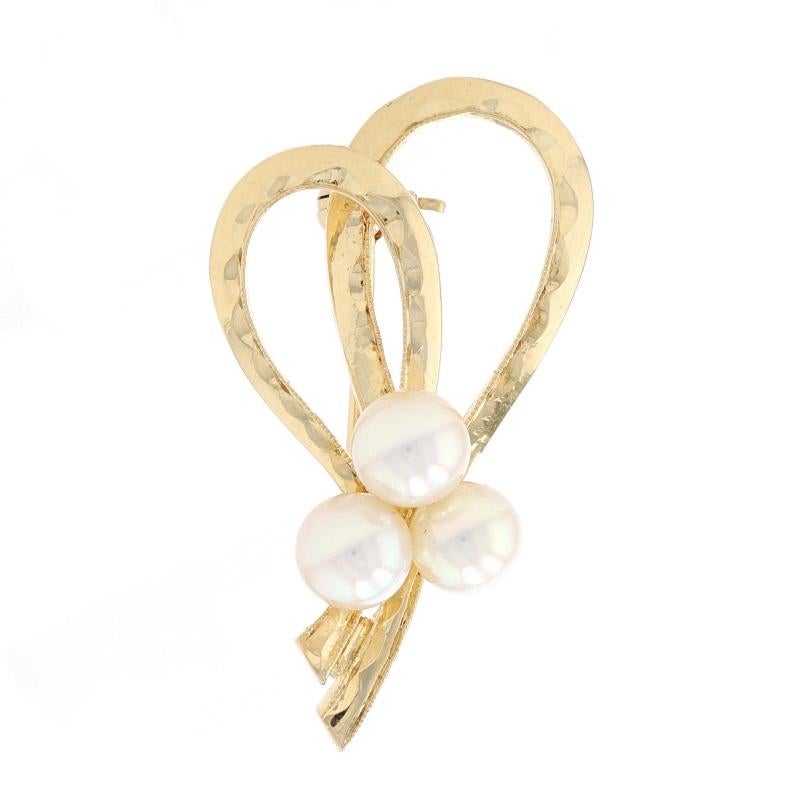 Brand: Mikimoto

Metal Content: 18k Yellow Gold

Stone Information
Akoya Pearls
Size: 5mm - 5.2mm

Style: Brooch
Fastening Type: Hinged Pin and Whale Tail Clasp
Theme: Ribbon
Features: Smoothly finished with scallop & milgrain