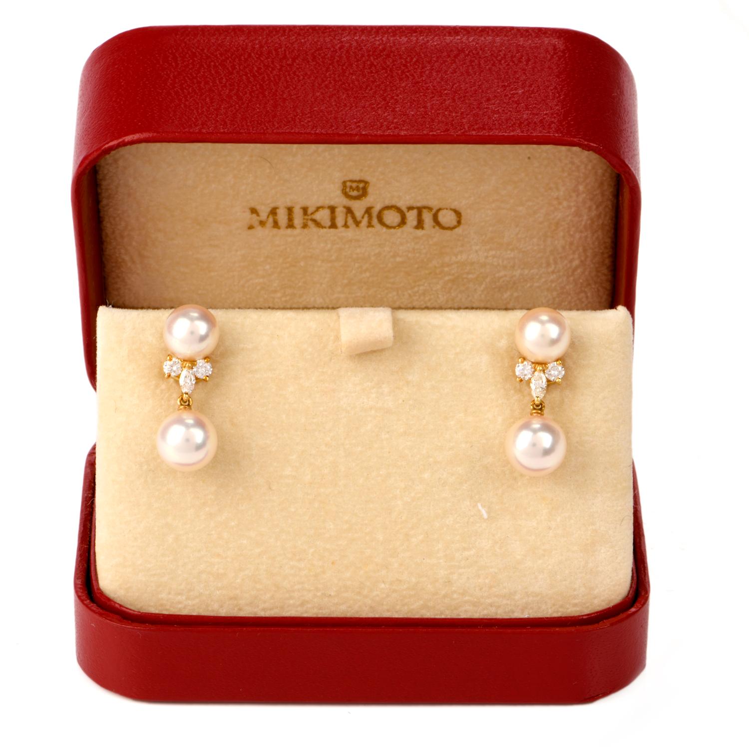 These beautiful vintage and elegant pearl and diamond dangle earrings are crafted in solid 18-karat yellow gold by designer Mikimoto. Showcasing two pairs of lustorous Akoya cultured pearls of white creamy color, measuring 8mm-7mm in diameter.